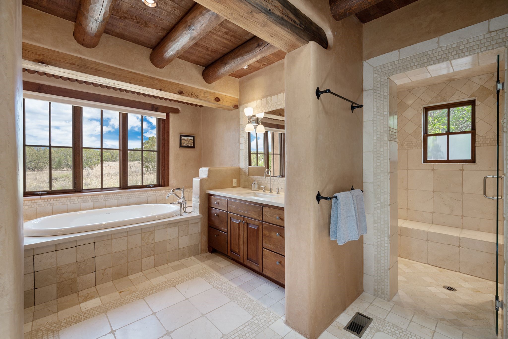 Jetted tub in master bathroom. Two separated vanities. Limestone countertops and floors.