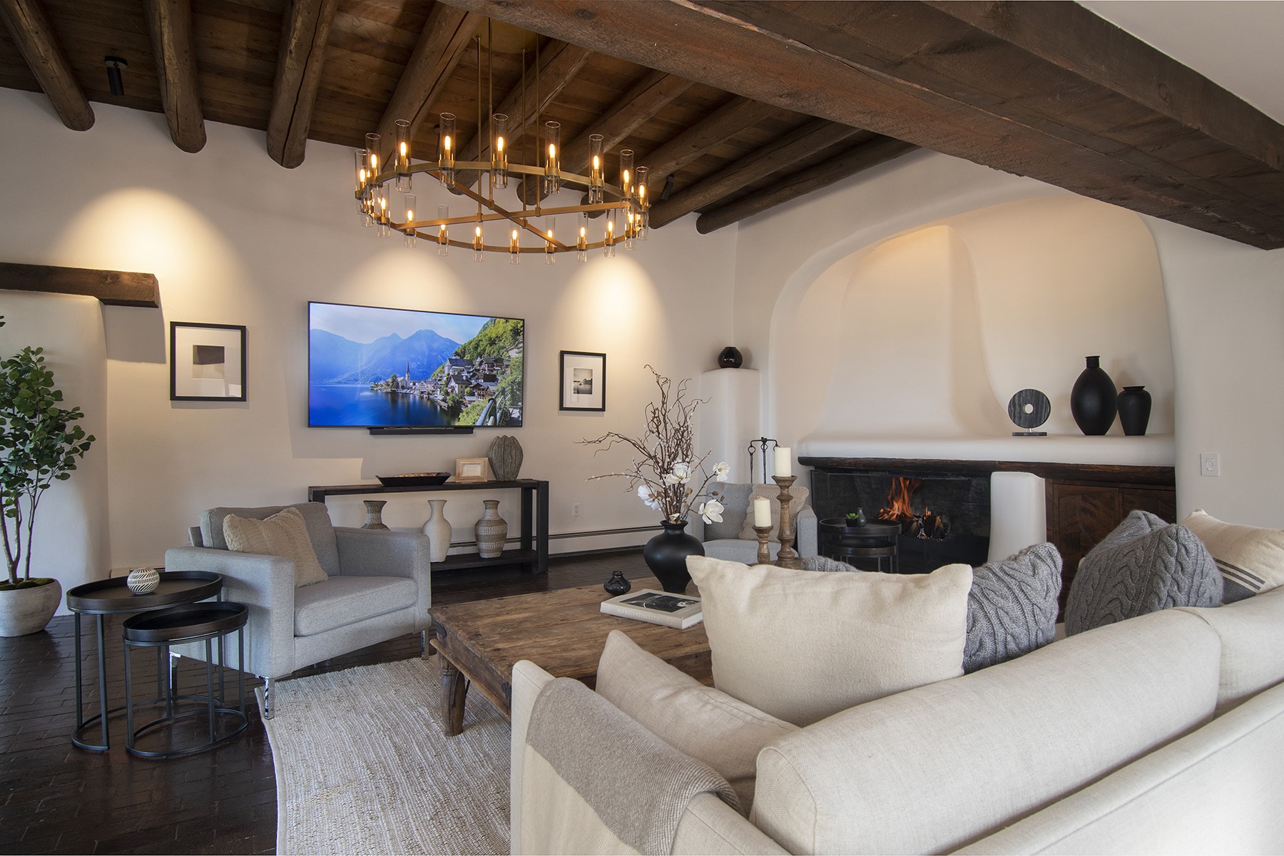 Living Room with vigas, brick floors and stunning architectural designed fireplace.
