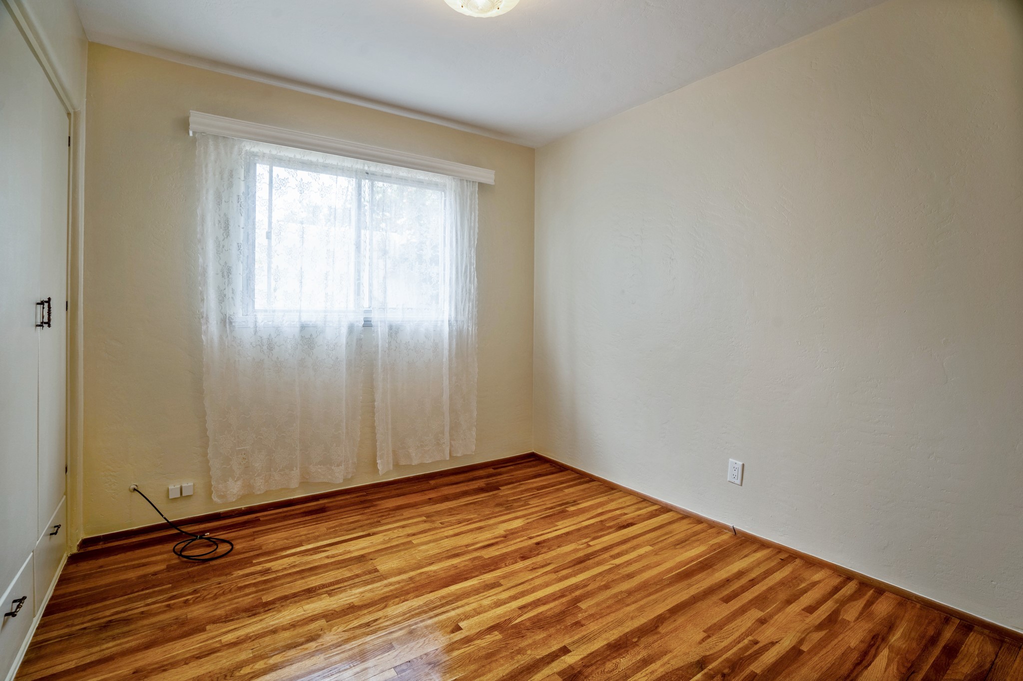 2nd bedroom with hard wood floors and built in closets