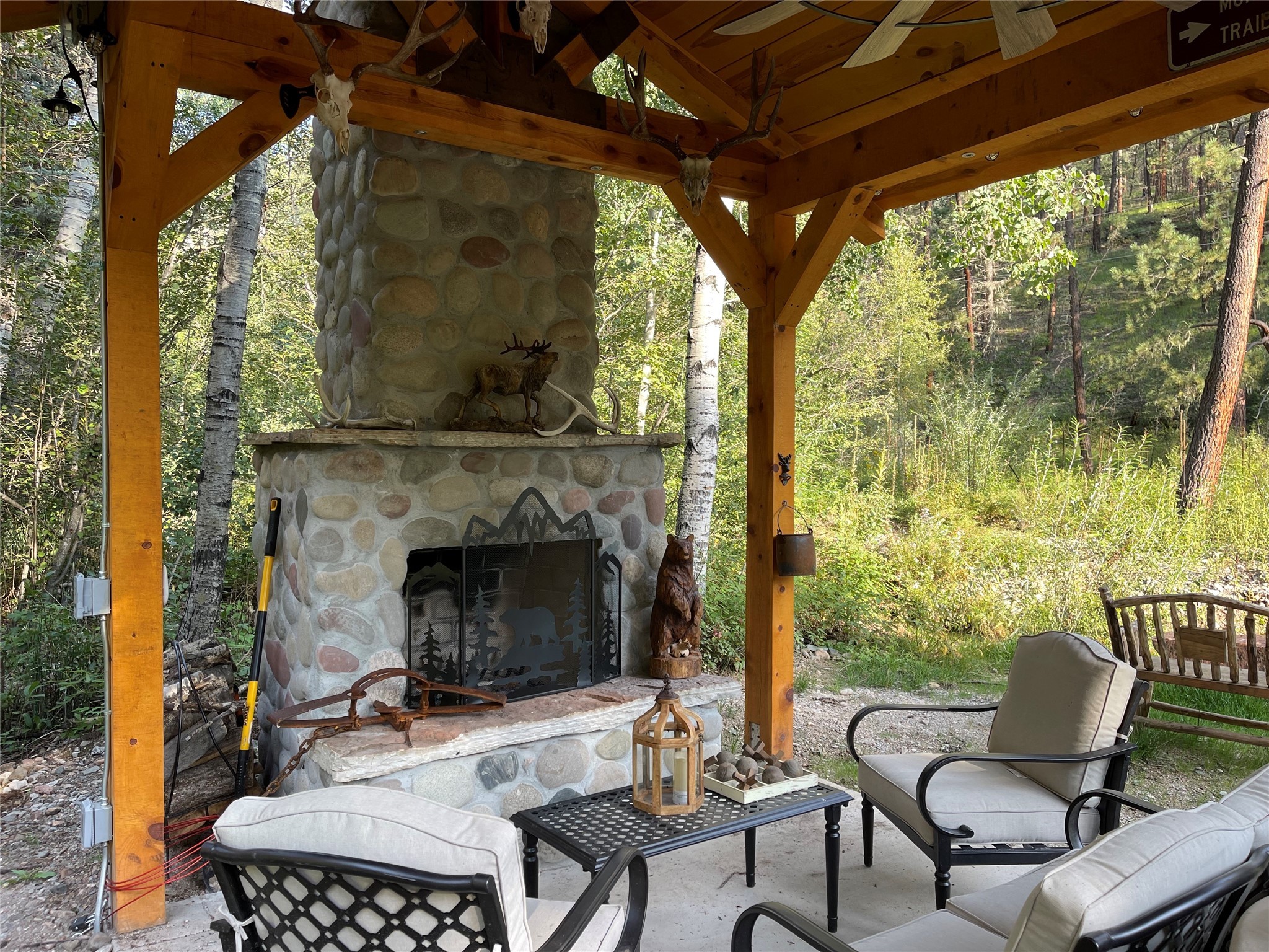 Beautifully crafted pergola and river stone fireplace