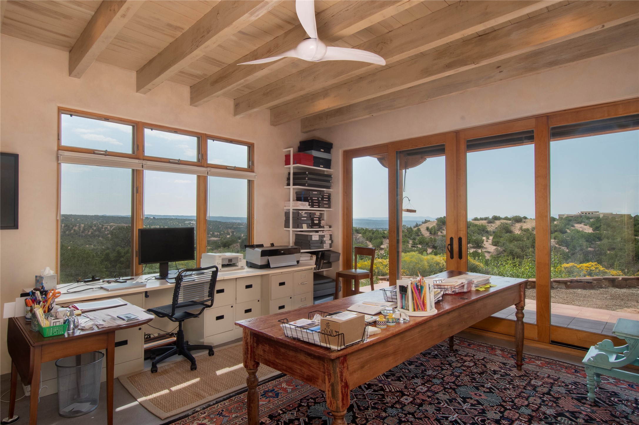 This bedroom, currently used as an office, has outstanding views of its environs.