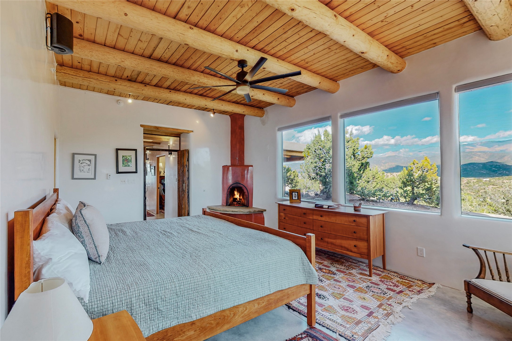 Primary bedroom with wood burning kiva and epic views
