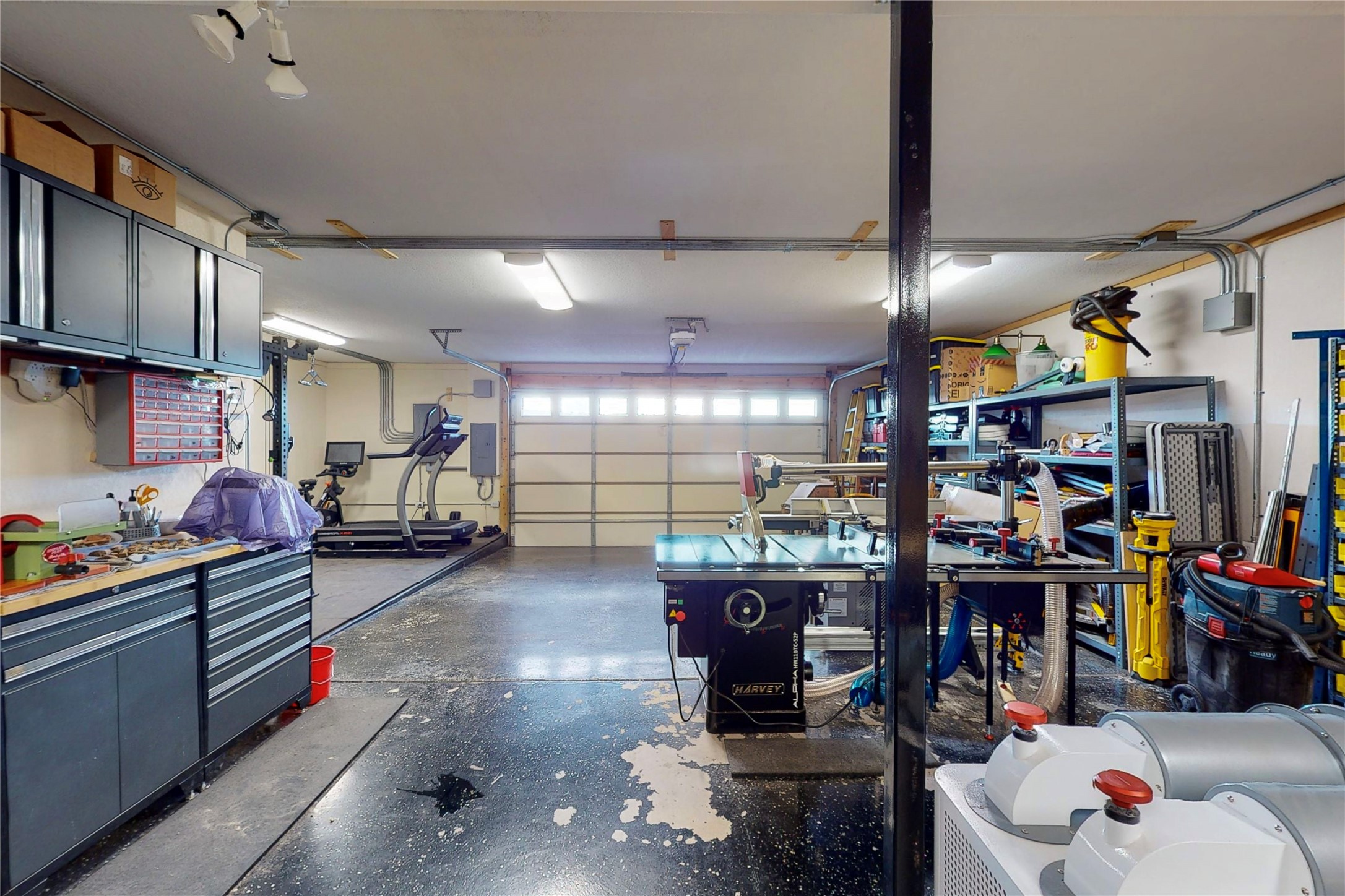 Oversized garage with plenty of room for a shop/gym/crafts