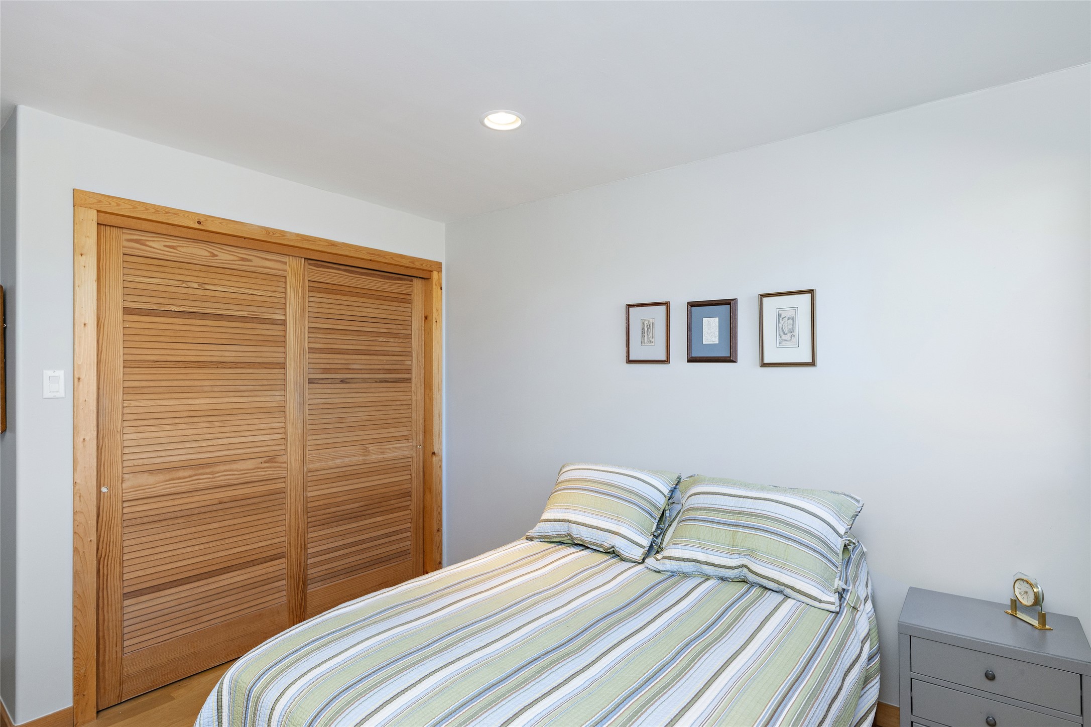 Light and bright second bedroom with hard wood flooring