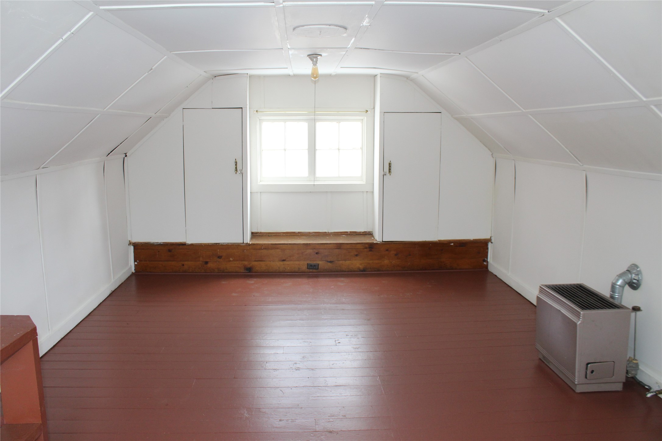 upstairs room with gas heater and closets