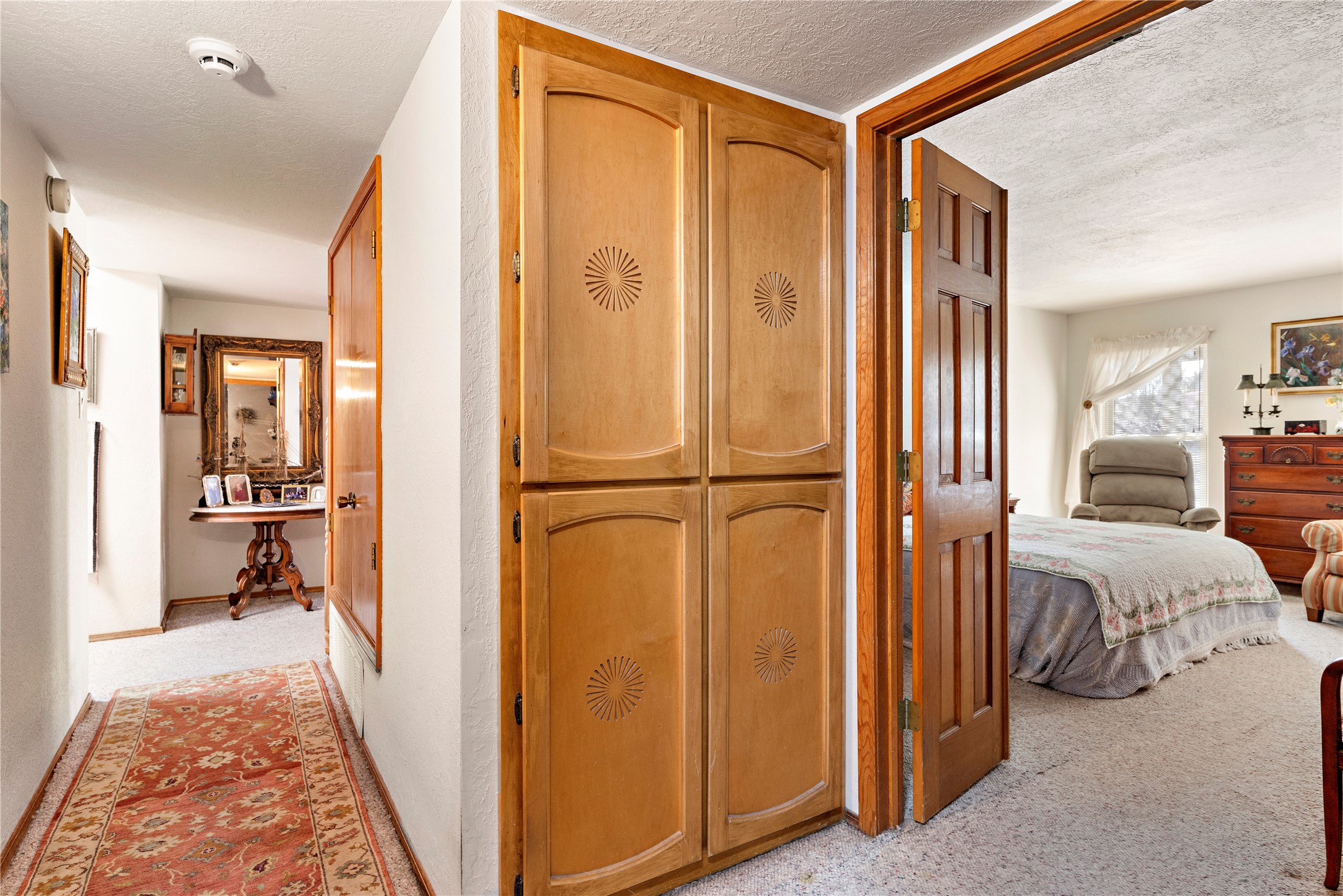 Built in linen cabinets at double door entry to primary bedroom.