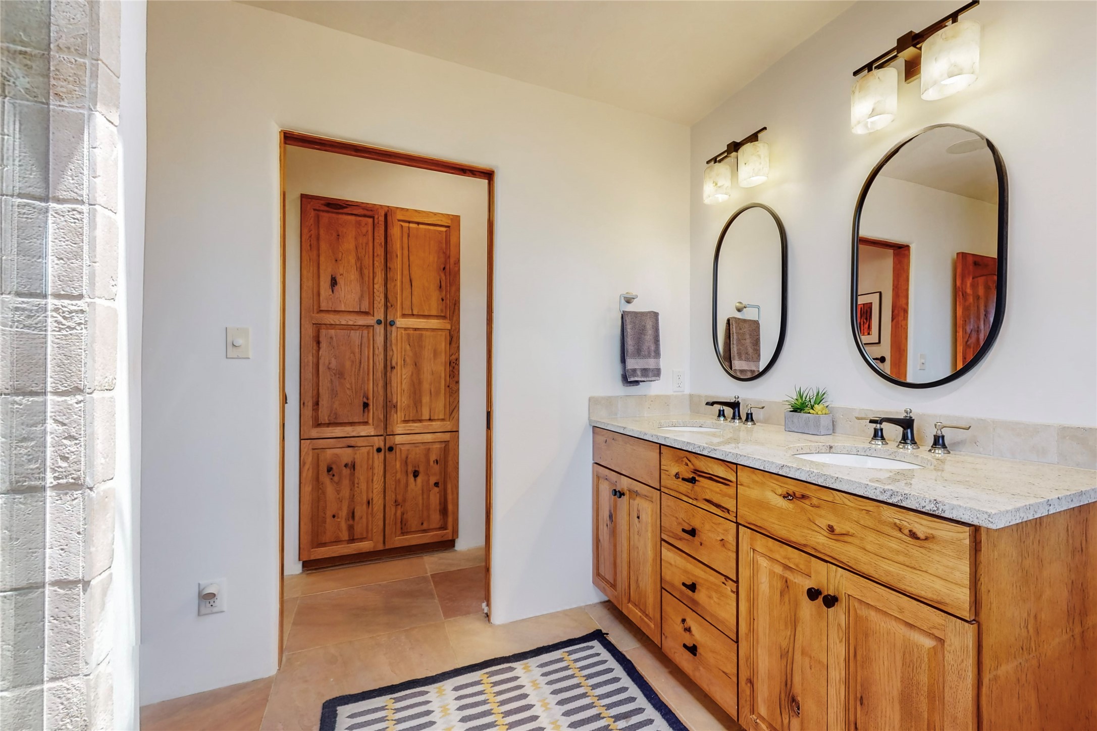 The bathroom in the primary suite, gracious and large, with bonus/linen closet