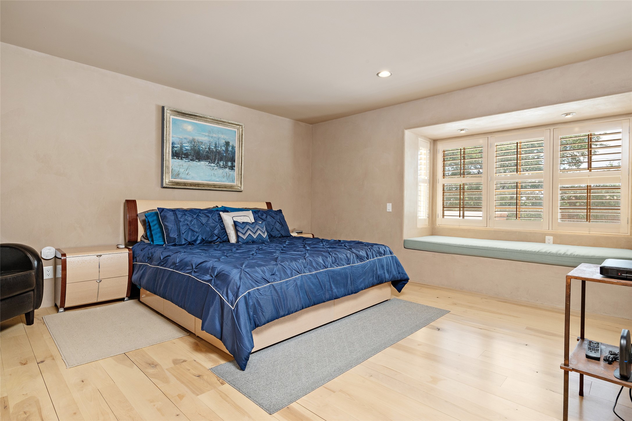 Very spacious primary bedroom open to the trees with hardwood floors and beautiful plaster walls