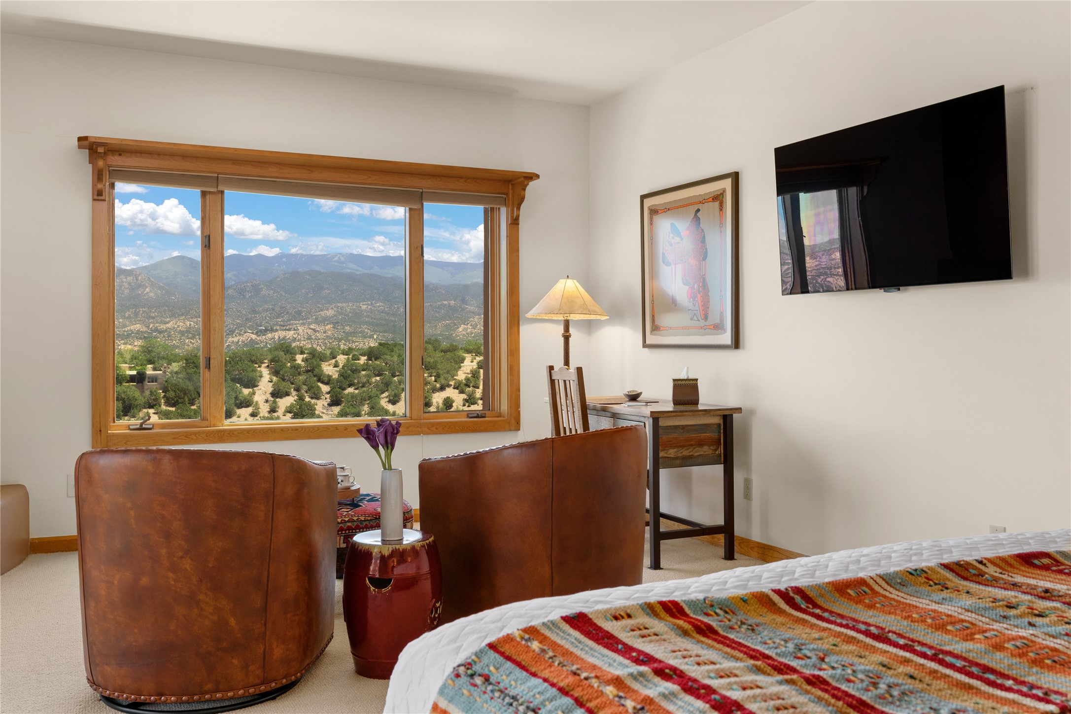 A wonderfully cozy bedroom with stunning views promises a restful night's sleep.