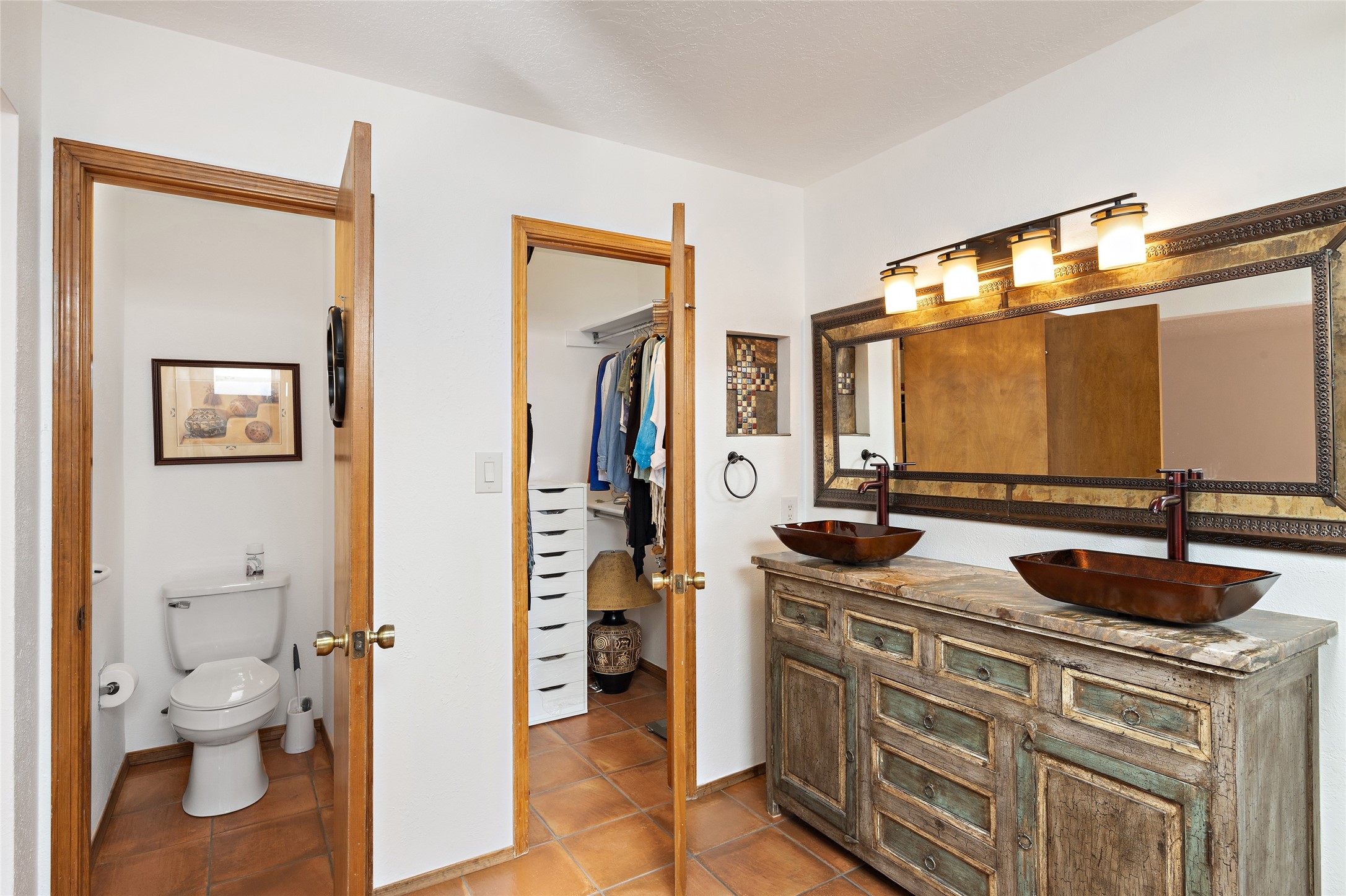 Large open primary bathroom with private water closet and the clothing closet