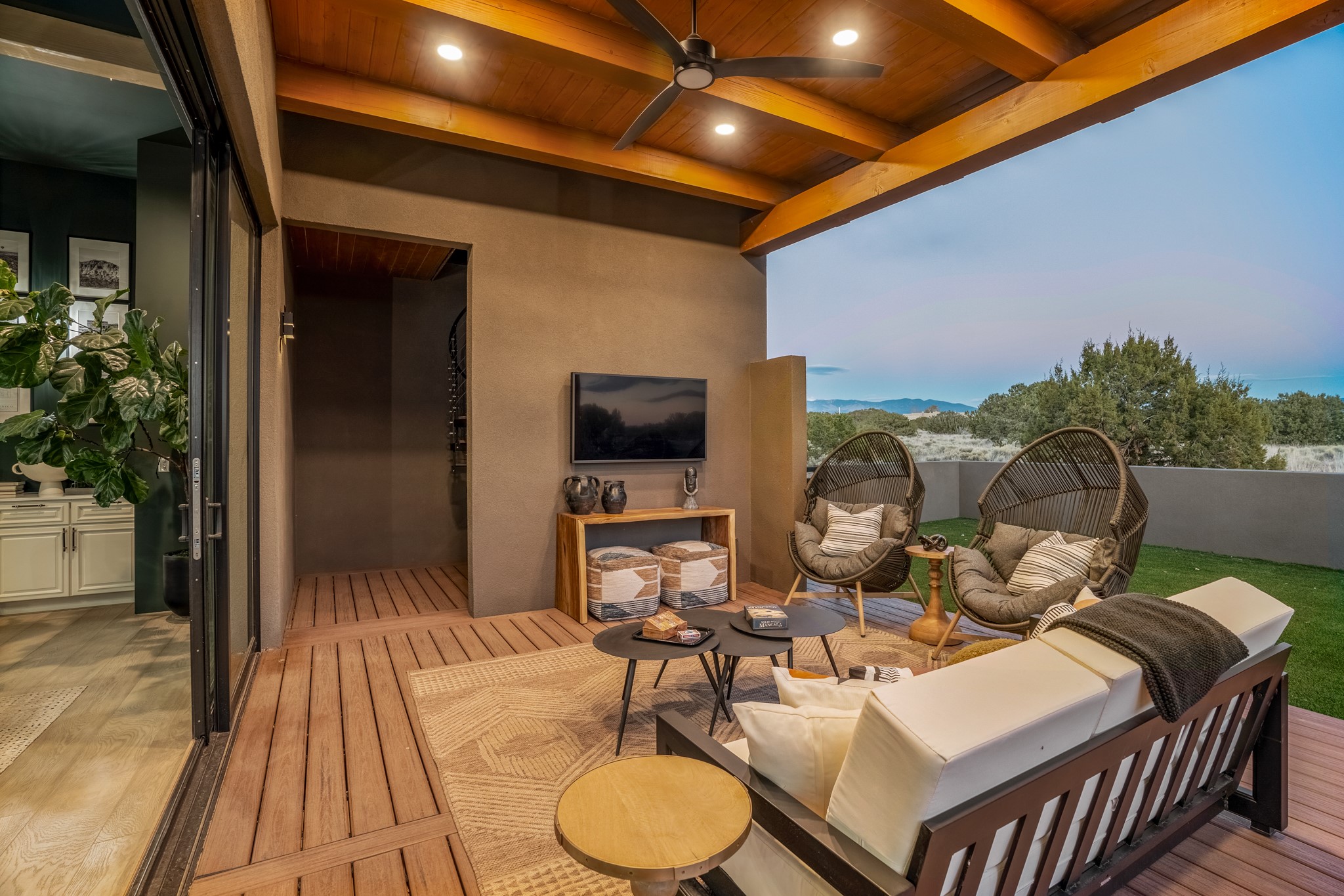 over 1550 sq. ft of outdoor living lounges under deep portals with exposed beams and illuminating views