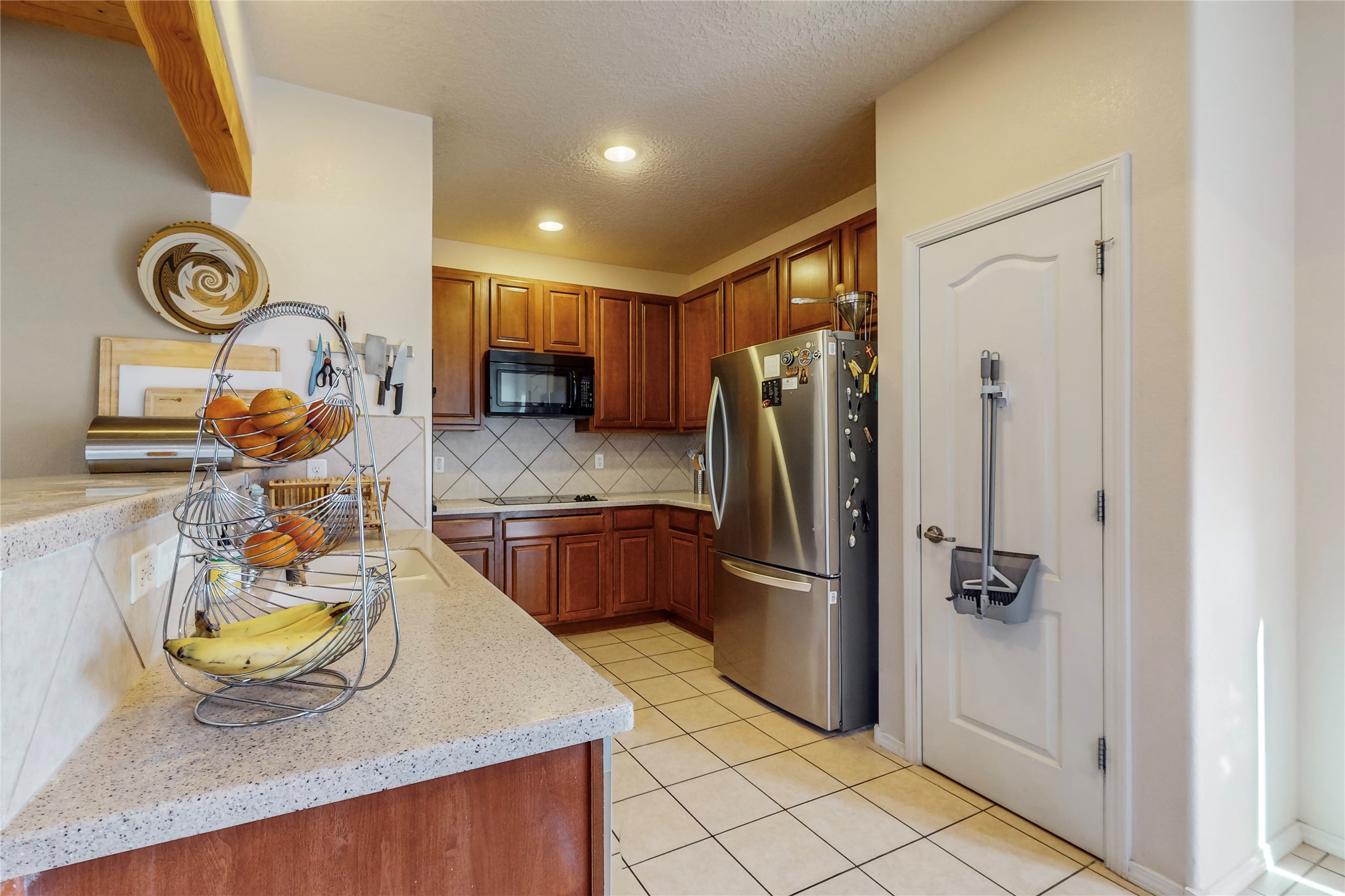Kitchen with large pantry, double oven, and breakfast bar. The kitchen opens up to the dining and living area