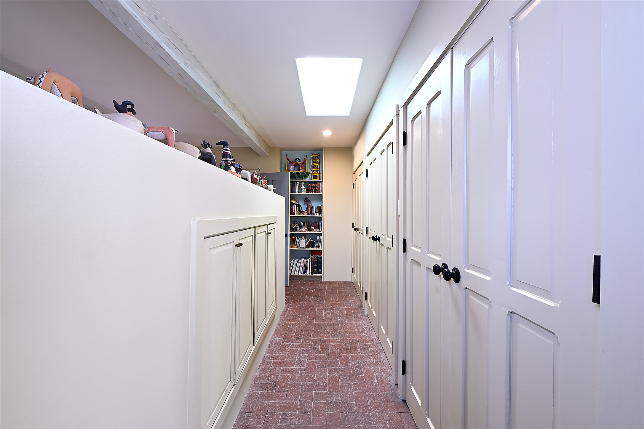 Along the back wall are several useful closets, while another wall is dedicated to built-in bookshelves.