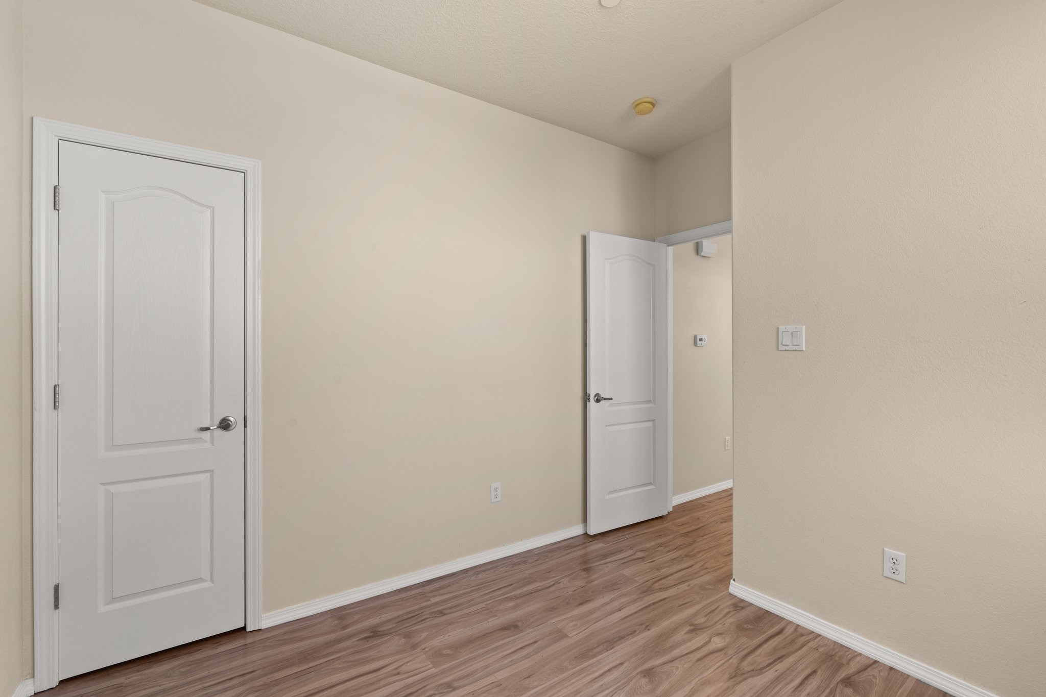 Downstairs Bedroom with walk-in closet. Ample storage throughout.