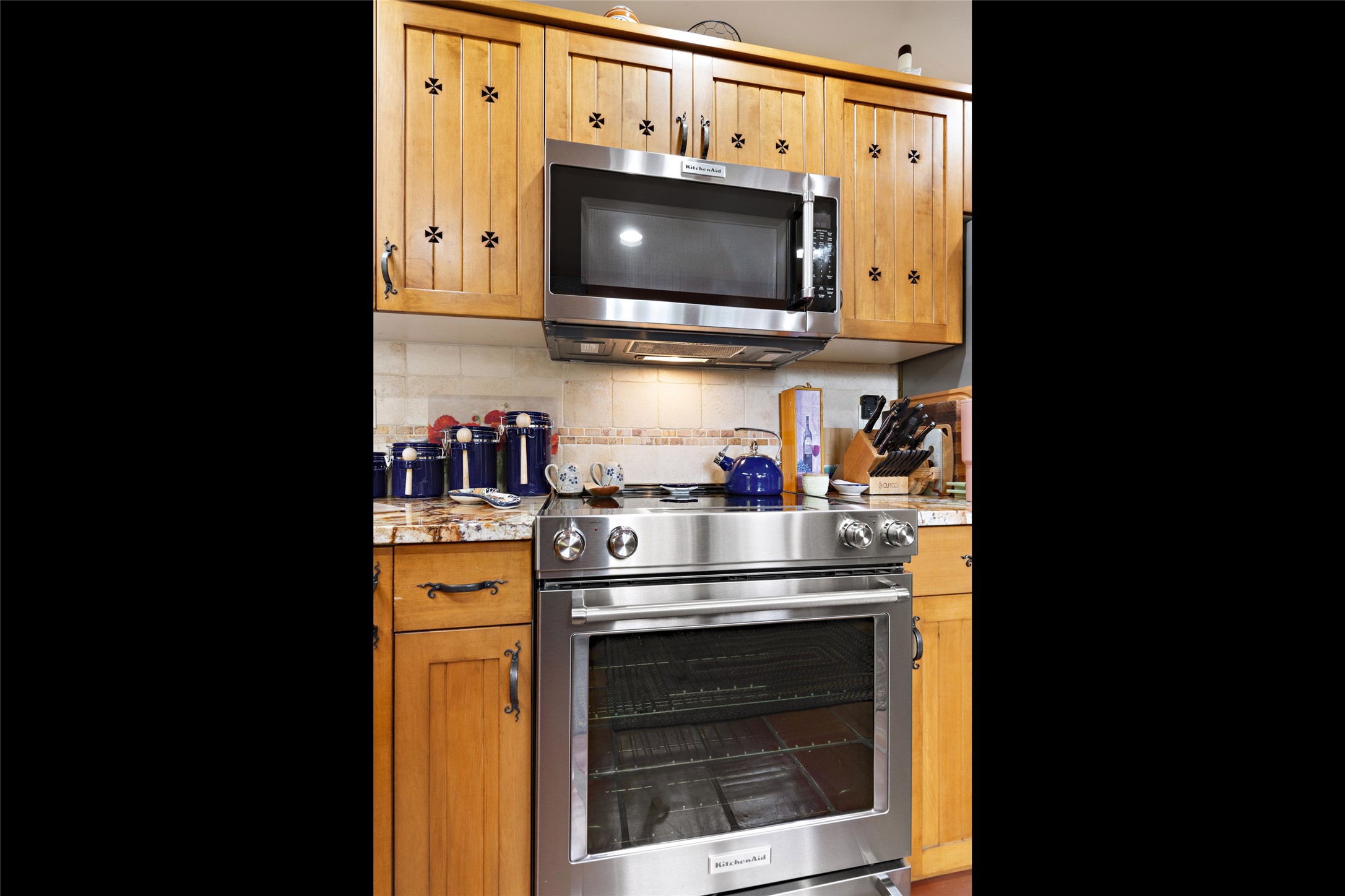Kitchen features Stainless Steel appliance package, custom cabinets and granite counter tops