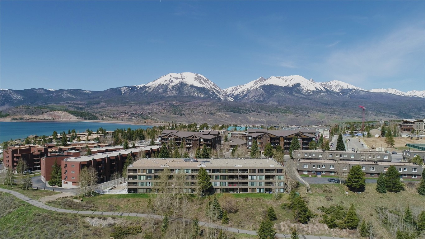 THIS BEAUTIFULLY FINISHED ground-floor end unit has plenty of space for you & your family or guests. Enjoy big west facing patio surrounded by aspen trees & the front lawn. Step outside & walk around to bike path, Dillon Marina, park & amphitheater. Features incl: 2-bdrms, living rm w/sleeper sofa, bonus space w/wet bar, 3-baths, & more; individual storage closet, workout center, meeting room, laundry, hot tub & outdoor pool. Pool to be completed later this summer. Long & short term rentals OK.