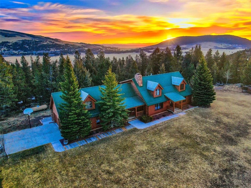 Custom Log Home on manicured property. Views of Buffalo Peaks. Log Masterpiece w/rustic look. Harwood floors & tile. Large basement w/8 foot concrete walls & floor. Deck & covered porch. Shed, Barn & Corral. Large bedrooms. Loft office area. Above Garage Bonus room. Aspen, Pine & Mature landscaping. In the heart of all things Rocky Mountain. Close to World Class skiing. Metro Denver area 1.4 hours away. Large acreages surround. True Log paradise in one of the World's most sought after areas.
