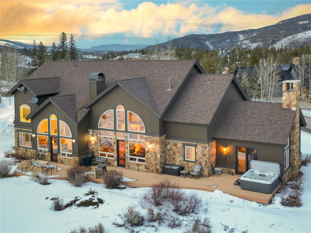 This gracious Highlands residence is located directly on the Breckenridge Beaver Golf Course, overlooking the second green of the Beaver with the majestic Baldy and Red Mountains in the backdrop.  Designed for years of enjoyment with multigenerational living in mind, this home features large gathering spaces along with wonderful separation of sleeping areas, all of which can accommodate a family suite design.  The floor plan boasts two Owner Suites, one on the main floor and one upstairs with a private balcony, as well as a luxurious home office so you can catch up on emails after a morning on the slopes.  The home was specifically designed to capture the mountain views, golf course setting and all-day sunshine from its oversized outdoor deck space.  Practice your chipping and putting in the evening as the sun sets and the golf course is all yours.  In the winter months, the golf course transitions to the Gold Run Nordic Center, so grab your cross-country skis for over 30K of impeccably groomed classic and skate skiing trails or 15K of snowshoe and fat biking trails.  The ease of access to all of which Summit County offers is second to none from this spectacular Highlands at Breckenridge home.
