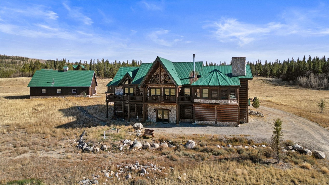 Surrounded by CO's natural beauty & 1 min off Hwy 9, this EXCEPTIONAL 5 BD/6BA property on 7+ acres perfectly blends mtn charm & modern comfort. Grab your fishing pole & walk across the road to fish HOA private waters along the South Platte River all while only being a short 25 min drive to Breck! Rustic exterior stone & log accents harmoniously extend inside. The home's grandeur is showcased with soaring ceilings, log beams, hardwood floors & thoughtfully placed windows. Custom cabinetry & buffet with metal inlays & stained glass enhance the home's character. Well designed mtn chic kitchen features new Quartz counters, SS appliances, 2 sinks & ample space for your culinary creations. The open floor plan flows seamlessly to an aesthetically pleasing dining area with its own gas FP, overlooking the South Platte River. After a day of mtn activities, relax by the wood burning stove in the well appointed Great Room. You'll never tire of enjoying the custom rock work, vaulted wood ceilings, book & art niches, impressive antler chandelier & massive views from the wall of windows. Not to be missed, the window lined den has its own gas stove & offers breathtaking views of the Mosquito Range. Retreating through the stone archway into the main floor primary suite, you'll find yourself immersed in comfortable elegance. The elevated ceilings, large walk in closet, ensuite bathroom, mtn views & another gas FP are just a few highlights of this perfect sanctuary. From the Great Room, ascend the open log staircase to the 2bd/1ba upper level. The Lower Level walk-out unit provides income potential with add'l space & versatility. Here you'll find 2bds/2bas, an updated kitchen, living/dining/office space with cozy gas stove & it's own entrance! Detached "Carriage House" provides yet another haven for private workspace, gatherings, game nights or simply unwinding in a quiet setting. With a gas FP, kitchenette/wet bar, 3/4 bath & office, this space calls for relaxation & inspiration.