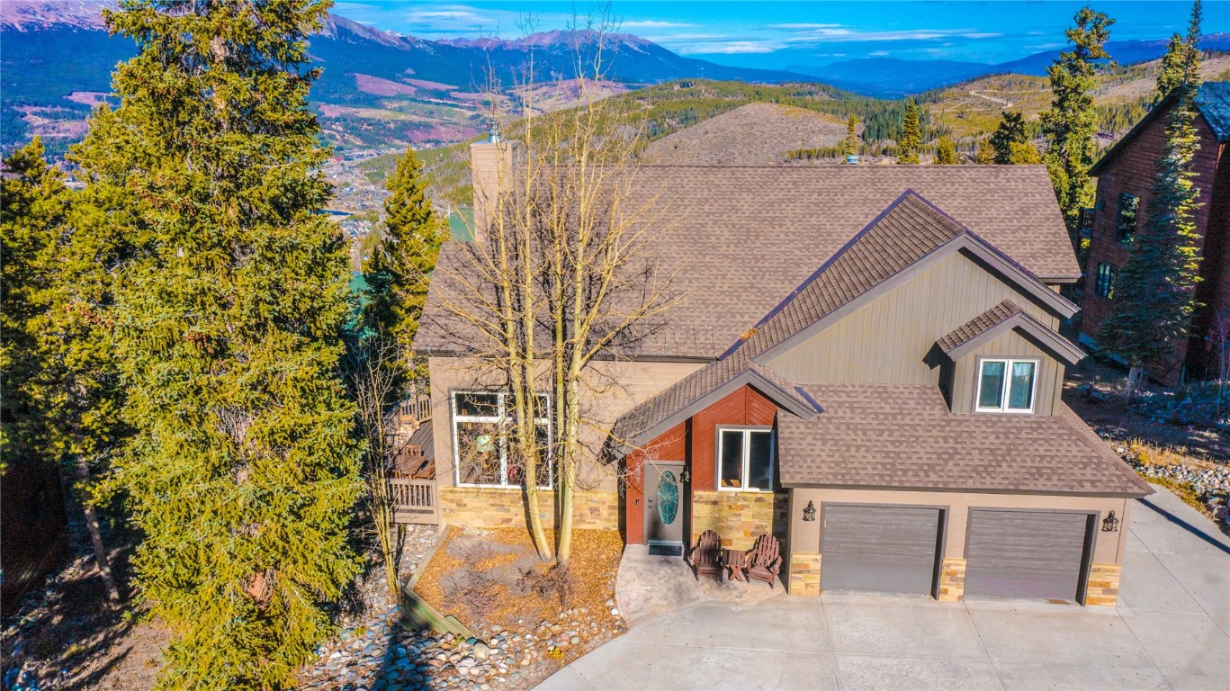 Just imagine waking up each morning in this updated home to breathtaking mountain views of the Ten Mile range including the ski area and overlooking the Town of Breckenridge! The majestic Baldy mountains can be enjoyed from the large deck or out the door for morning hiking and biking. Whether you're a snow enthusiast or simply love the serenity of mountain living, this home offers a private hot tub, flagstone patio and close proximity to hiking, biking and snowshoeing trails. Inside, you’ll be greeted by the warmth of a floor-to-ceiling stone wood-burning fireplace with a gas hookup, hand scraped wood floors and a large kitchen perfect for shared cooking. This home also has a 2 car heated garage and can be used as a 3 bedroom 2.5 bath and lock-off 1 bedroom and 1 bathroom in-law suite complete with its own parking space giving this home additional income potential. The home can also live as a 4 bedroom, 3.5 bath. A 10-minute drive away from the gondola and Main Street of Breckenridge. Prefer to leave the car behind? It's also just a short stroll to the free shuttle stop.