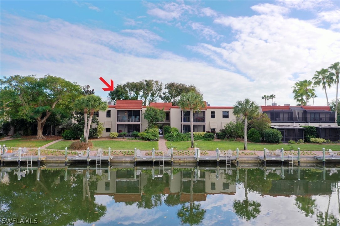 Peaceful waterfront views of the canal with frequent dolphin, manatee and bird watching! Sanibel Moorings is a gorgeous complex with both Gulf-front and canal-front condos, plus 6-acres of botanical gardens. This 2bed/2bath unit is on the canal, overlooking the water and boat docks below. Inside, a spacious wrap-around kitchen has granite countertops and beautiful cabinetry. A kitchen island offers additional storage and connects the dining room table with matching countertops. Relax in the living room or slide open the glass door that leads to the screen-enclosed balcony overlooking the canal.  A spacious guest bedroom with built-in cabinets has a bathroom with granite countertops and a shower/tub combo. The primary ensuite includes a tiled shower, spacious walk-in closet and a locking closet w/ stackable washer/dryer. Outdoor owner's closet w/ bikes, fishing/beach gear. Sanibel Moorings has 2 pools, 2 tennis courts, lounge, gardens, grills, boat docks, bike rentals, and onsite mgmt.