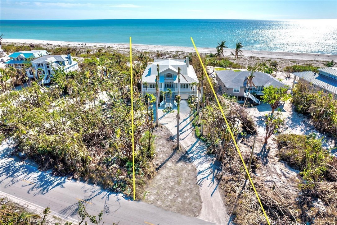 Opportunity is here for you! A home that was built and designed with quality in mind. A timeless island feel this fantastic premiere West Gulf Drivedirect beach front home offers a large beach front pool, 4 bedrooms 5 1/2 baths, den, HUGE lot. 2 Thermador wall ovens , Sub-Zero refrigerator, built in woodcabinets in den and living room, fireplace, woods floors, tile floors, incredible dinning room, granite island in breakfast bar kitchen, gas cook top, whole home generator, 3 tank less hot water heaters, elevator, in house vacuum. This is a great upscale beach house offered at an exceptional price. This home is spectacular and ready to be even more spectacular. The garage level and pool has had water intrusion and is ready for the next person to fix up or leave open to enjoy huge open living space. Home did not have water intrusion on the first and second living floor.