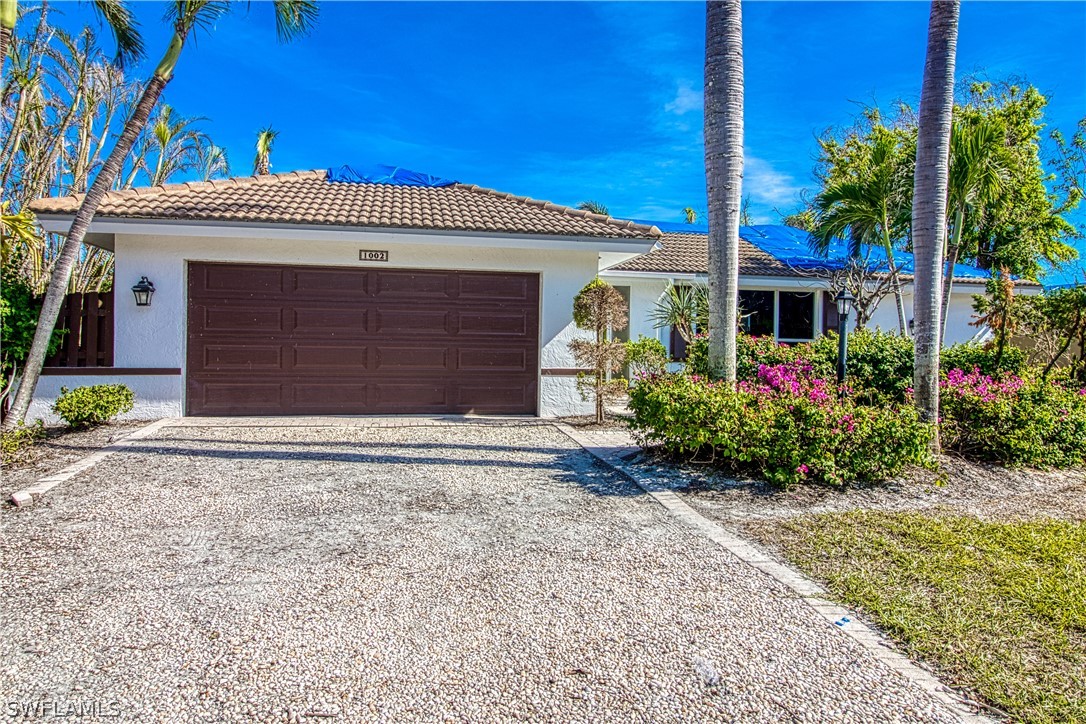 Dynamic Duo!  Deep water canal front home with quick gulf access and near beach accesses.  Shell Harbor community is simply the best location on Sanibel's East End, which is close to the causeway for easy access on/off island, close to shops and dining.  Residents enjoy deeded beach access, private beach parking and boardwalk.  This solid ground-level home with tile flooring throughout & vaulted ceilings has been remediated and drywall removed to the studs following water damage from Hurricane Ian.  The home is ready to customize to your exact preference.  Pool,  electric & water has been restored and debris cleared.  Roof is tarped, but no signs of leaking.  This home features a boat dock with paver decking & seating area, 12,000 lbs.  boat lift, privacy from mangroves across the canal,  paver lanai,  and hurricane windows.  Prior to hurricane, the landscaping was a tropical oasis which is already showing signs of re-growth.   This home is being sold "AS-IS."   If your dream has been to own a home on Sanibel, this is a great property to start and be part of the rebuild of Sanibel Island.