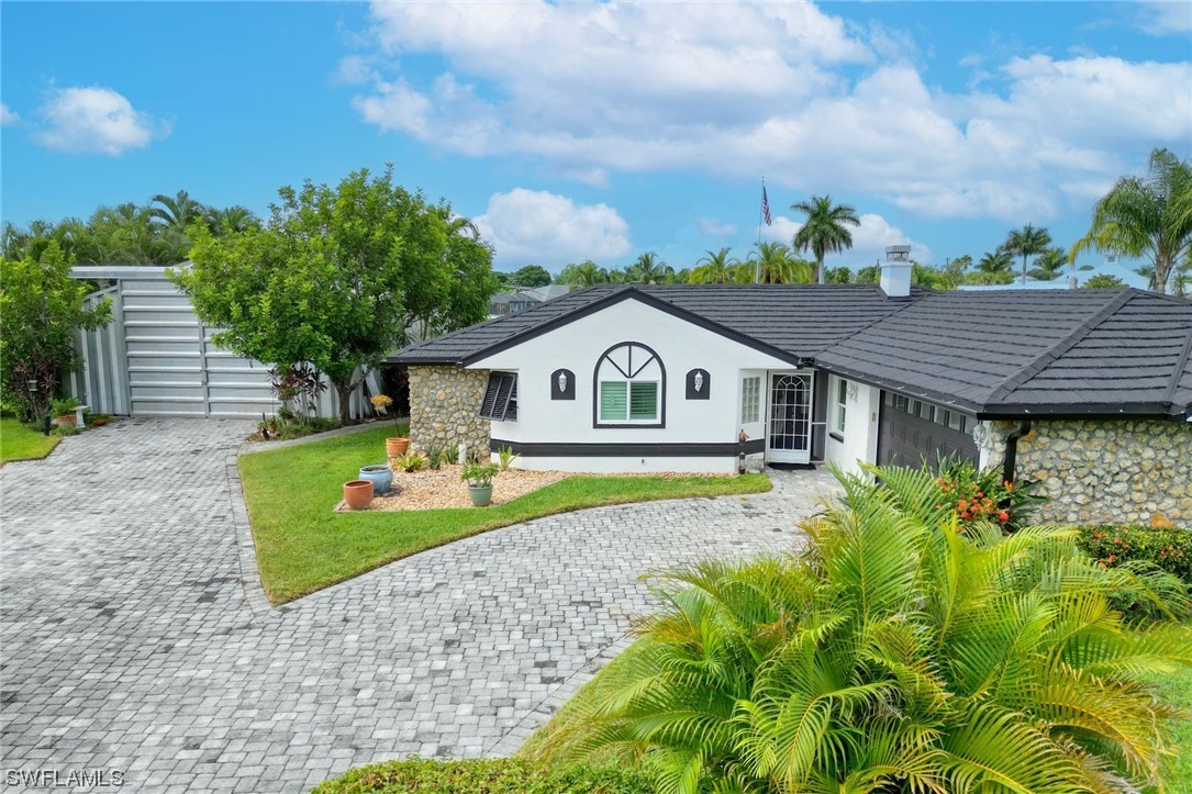 It's rare to find a property like this w/ direct deep-water access, a coach house, and a remodeled from-top-down pool home on OVER HALF AN ACRE, fenced and gated. Enjoy the intersecting canal views and access to open water within minutes by boat. With 120 feet of seawall, there’s plenty of room for your custom dock. Bring your RV, cars, and toys! Use the extra building/coach house as a workshop, parking/storage, or man cave. There’s electric available for RV hookup. NEW IMPROVEMENTS include temperature and sound deadening foam coating, cable hookup, slider doors to the canal and pergola, hangar-style garage opener, and LED lights.  
SO MANY UPDATES during renovation: stone-coated metal roof w/50-year warranty, hurricane impact doors and windows throughout, updated kitchen with gas appliances, new water filter system, luxury vinyl flooring throughout, resurfaced pool, new electric blinds, new exterior and interior paint, and epoxy floors in the garage and coach house. No HOA, no rental restrictions, no city taxes or assessments. Don’t delay, watch the virtual tour, and set up your showing today! DON'T MISS OUT! SELLER MOTIVATED.