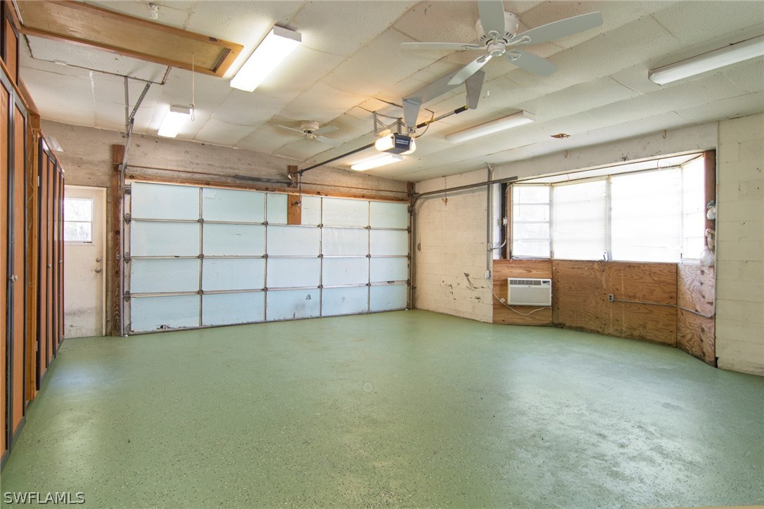 Huge 24x20 insulated garage with lots of storage, work bench and window unit AC. It has brand new floor paint.