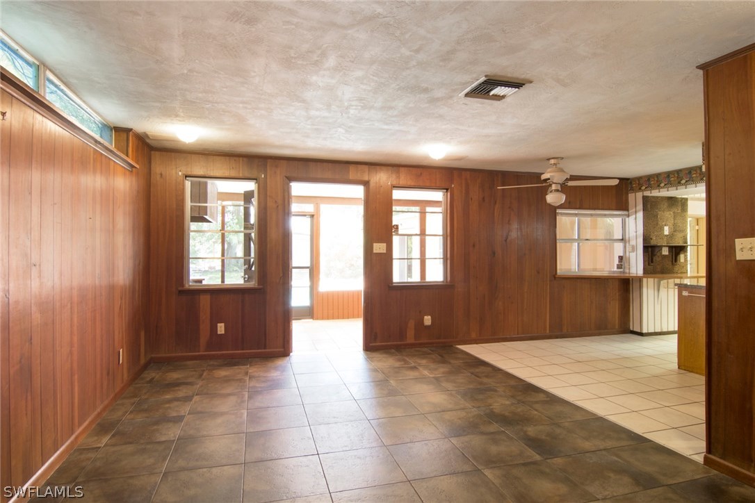 Big Family/TV room has tile floor and opens to kitchen and screened lanai which is tiled.