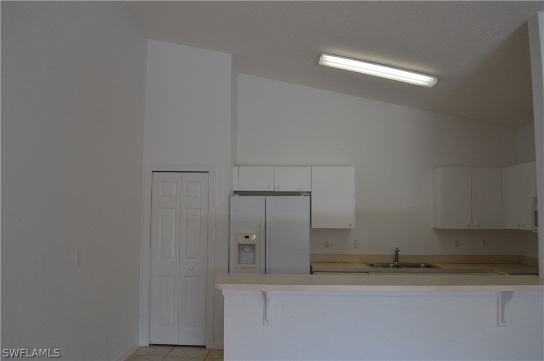 Large bright kitchen features Pantry, Range, Refrigerator, Microwave and Dishwasher and great counter bar.