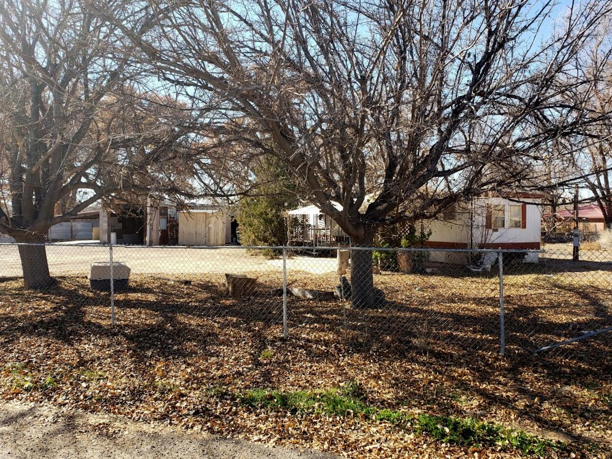 Half Acre Opportunity in Peralta NM. The Home and Out Buildings to Convey As Is.  Tons of storage. Nice trees.