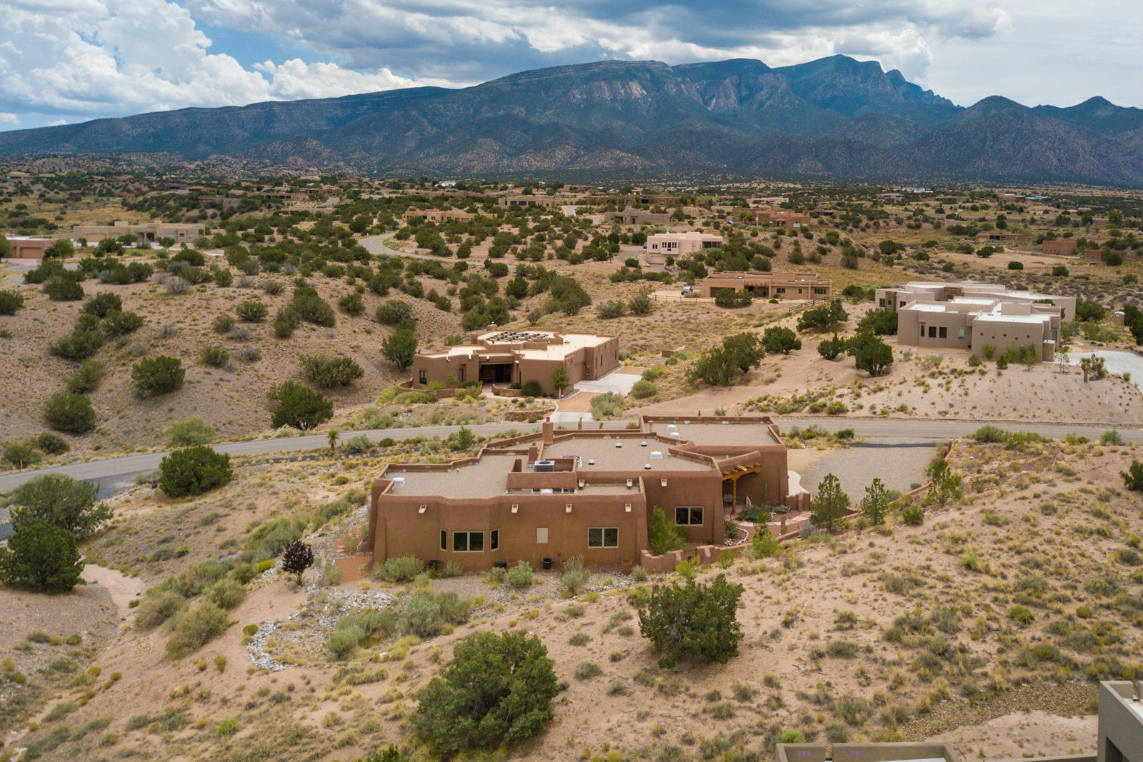 This single-level Southwest style home, located on a .91 acre view lot in Anasazi Meadows, was built with the incredible views of the Sandia Mountains in mind. Its features include raised, beamed and latilla ceilings, tile floors throughout, lighted nichos and custom wood burning kiva fireplaces in the great room & master. The kitchen features custom cabinets w/ pull out shelves, level 5 granite counters, stainless appliances, pantry and breakfast bar. Enjoy the views from the spacious master bedroom which features an exercise/sitting area opening to the covered patio. The en-suite bath features a massive closet, jacuzzi tub, large shower and water closet. Outdoor living spaces offer many opportunities for entertaining or relaxing! Please click ''more'' for additional features & info