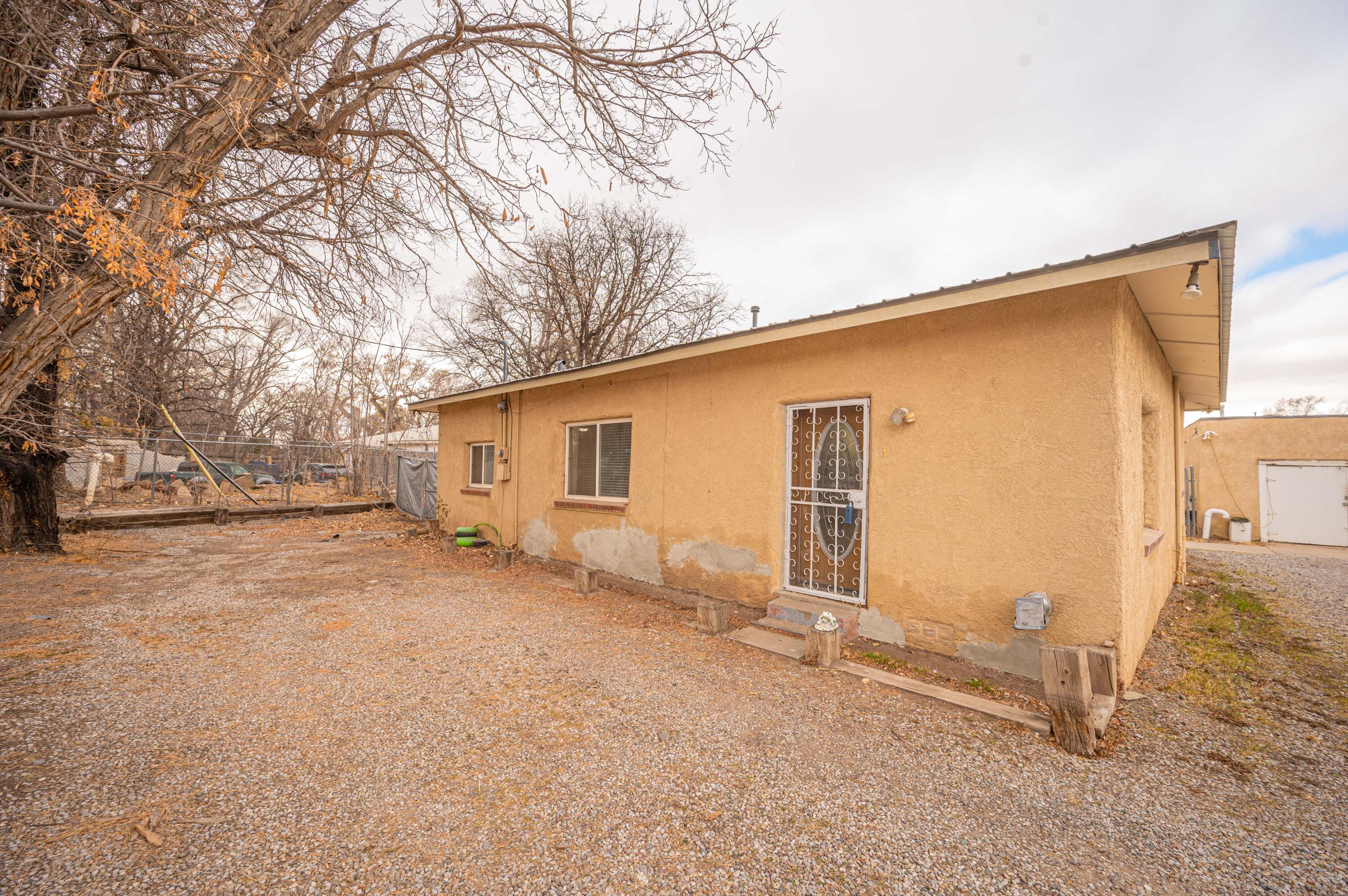 A nice 2 bedroom adobe home on a 1/4 acre in the South Valley. Enjoy your yard from either the covered patio or screened porch. Water is on private well but sewer is city. A great investment opportunity. New metal roof and updated bathroom (less than a year). Come, visit and make this home yours!
