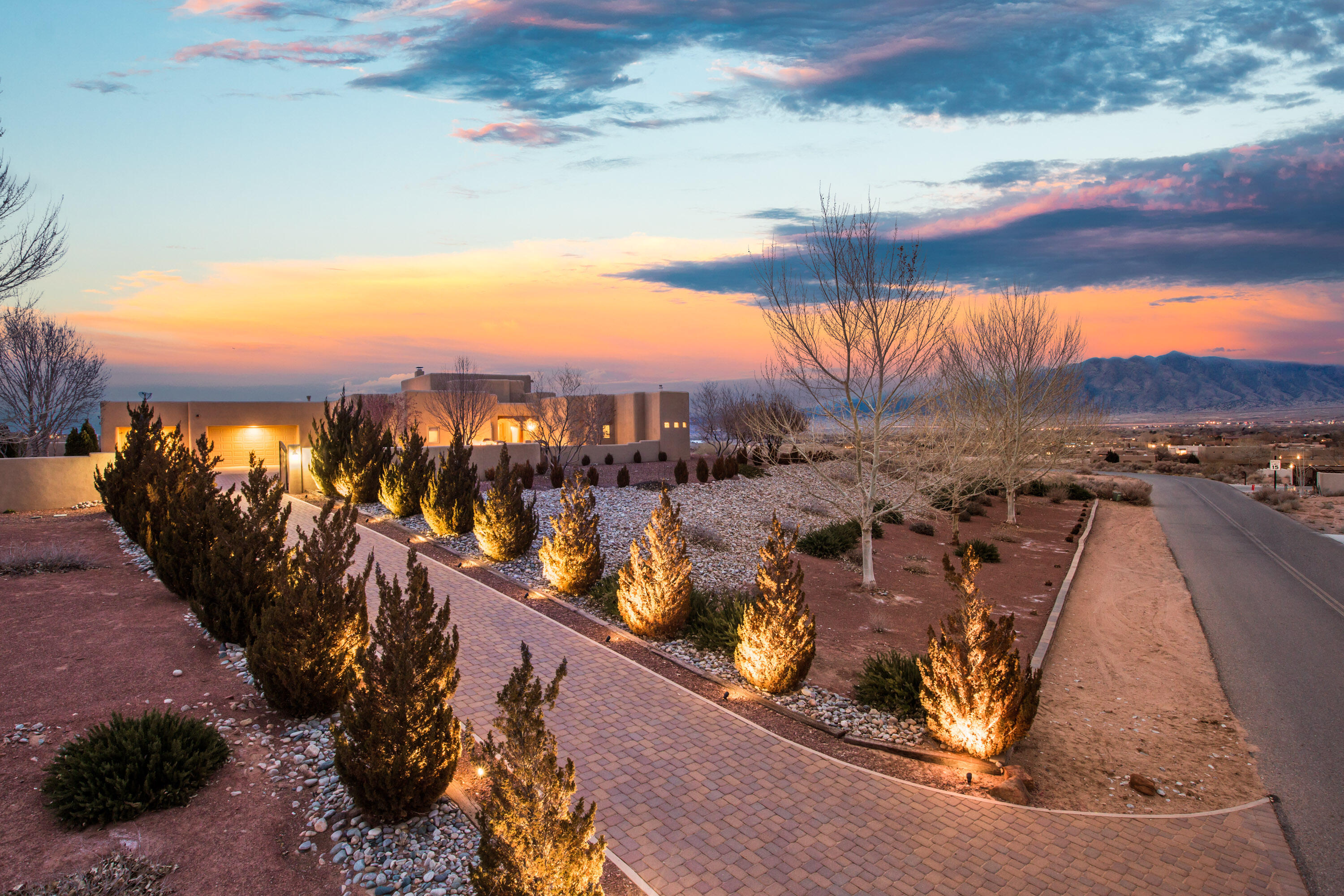 Each sunlit corner of this custom pueblo shines with luxury. Private owner's wing, generous rooms & courtyards. This is a retreat! Xeriscaping compliments desert beauty & inspiring views of the city & mountains. Arches into wings of the home flank the elegant entry. The owner's ensuite is a personal spa w/ dual vanities, jetted garden tub and walk-in shower. Living room features soaring wood ceilings, beams & kiva fireplace for warmth and ambiance. Chef's kitchen features granite, travertine backsplash, knotty alder cabinets, top-of-the-line appliances, island & butler's pantry. Solarium, 2 offices, media room & inner courtyard. Every window frames a gorgeous view of the landscape & artfully designed exterior w/ backyard that's ideal for al fresco entertaining.
