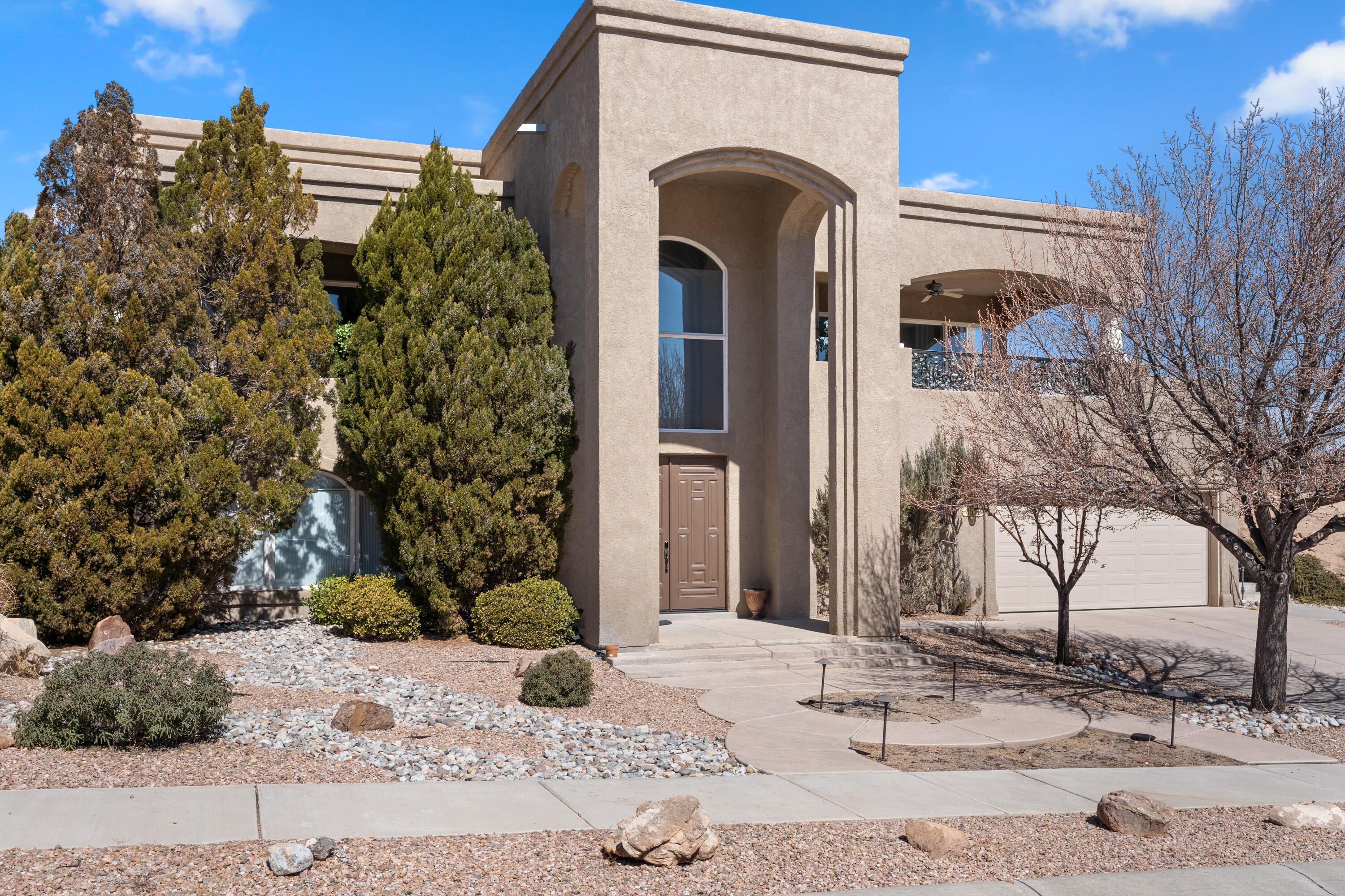 This custom-built luxury home was designed to enjoy the amazing views of Albuquerque's city lights and the Sandia Mountains. Step inside to the elegant entry way with custom iron banisters and railings, and one of two built-in display cases. Upstairs is the formal dining room, large living room with the cozy gas fireplace. Views from the double sliding glass doors display the entire city, perfect place to enjoy the Balloon Fiesta and 4th of July. In the kitchen you'll find all stainless-steel appliances, downdraft cooktop and granite counters. All bedrooms have full bathrooms with walk in showers and large walk-in closets.Downstairs you will enjoy the 3rd bedroom with private bathroom and walk in closet.