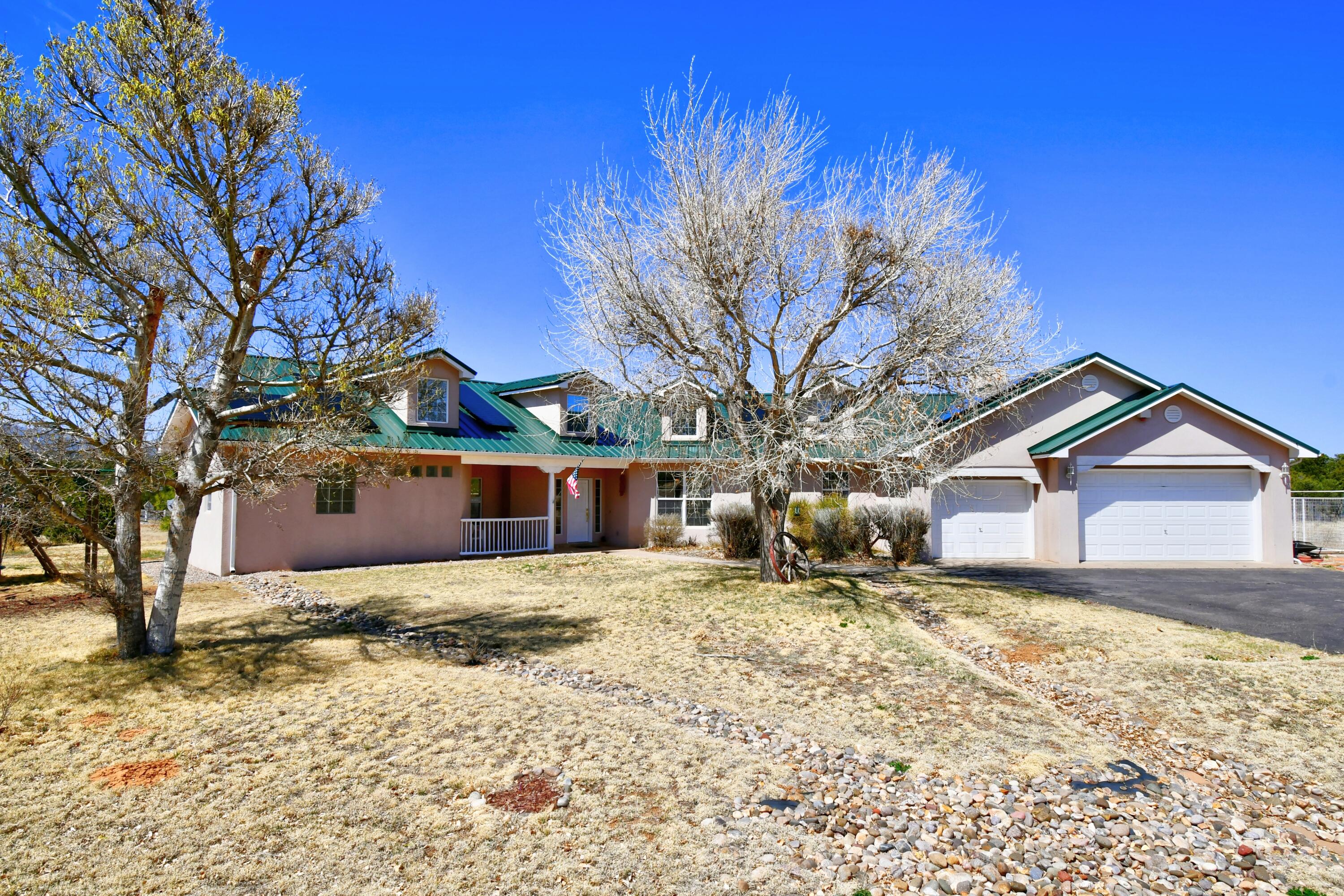 Stunning single level home with fully owned solar system on 3 acres in the desirable Richland Estates neighborhood!   Open floorplan that leads out to a private backyard area with covered patio, plenty of space for entertaining and VIEWS of the Sandia Mountains. Large kitchen with custom Halbert cabinets and island open to the dining room. Split floorplan and spacious master suite with fireplace, jetted tub and large walk in closet and separate shower. 3 bedrooms, plus an office or 4th bedroom with glass french doors and kiva fireplace. Recent updates include newer Metal roof(2020), owned solar system with amazing East Mountain perks including community water, No HOA and 3 car garage.