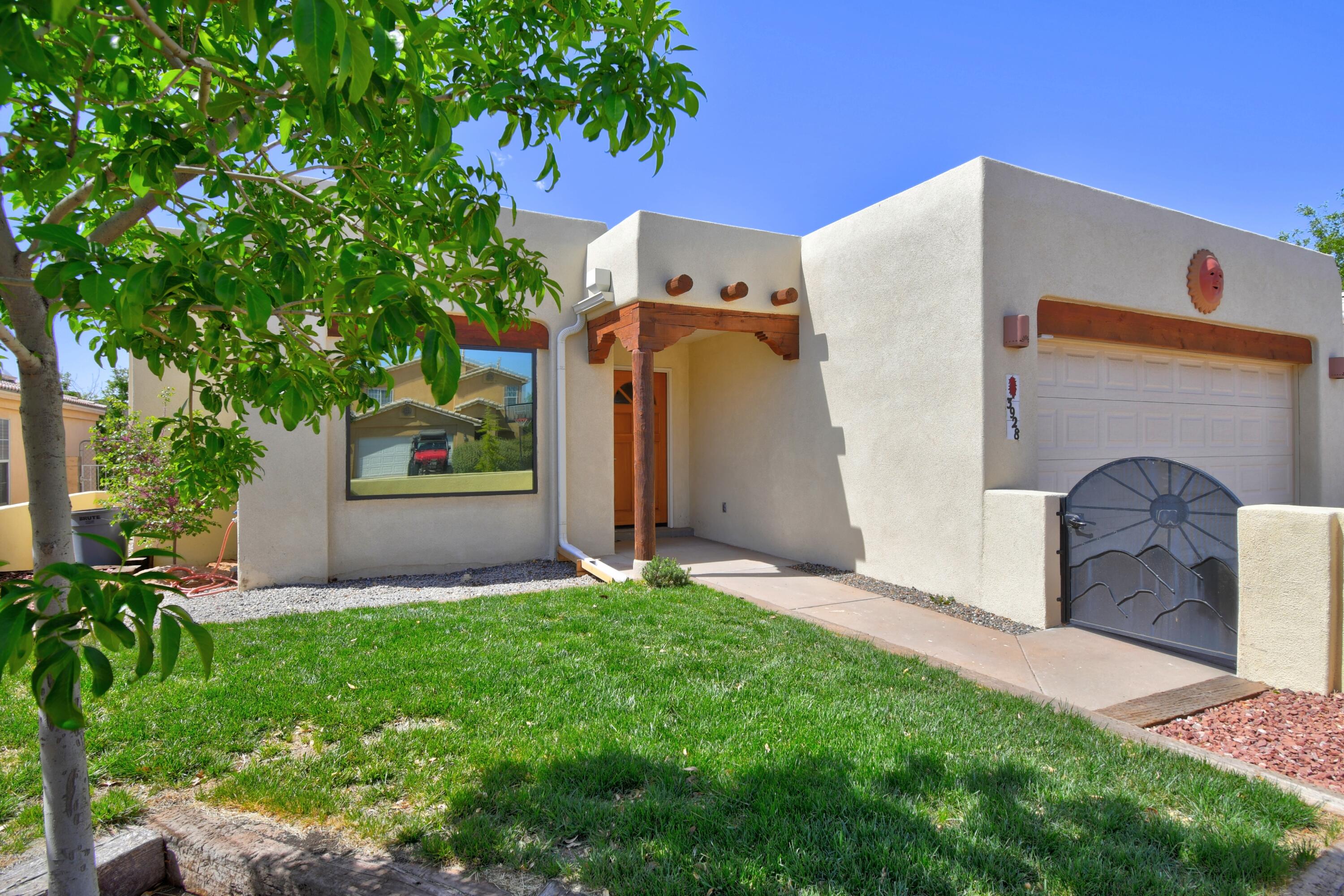 Beautiful upgraded one story pueblo style home in the Casita del Norte neighborhood. 3 bedrooms/ 2 baths, with a spacious master bathroom and dual sided fireplace in the bedroom. The kitchen has a butlers station, updated custom cabinets with glass doors along the ceiling uppers, stainless steel appliances, Viking gas range, granite countertops and tons of natural light! The living room has laminate flooring, wood burning kiva style fireplace, high tongue and groove ceilings with viga beams that give the living room a custom feel. Roof and evaporative cooler, stucco, windows were replaced within the last 3 years.  The backyard has a large covered patio, rooftop access and raised planter beds for gardening make this backyard a gardener's dream!!  This home is a must see!