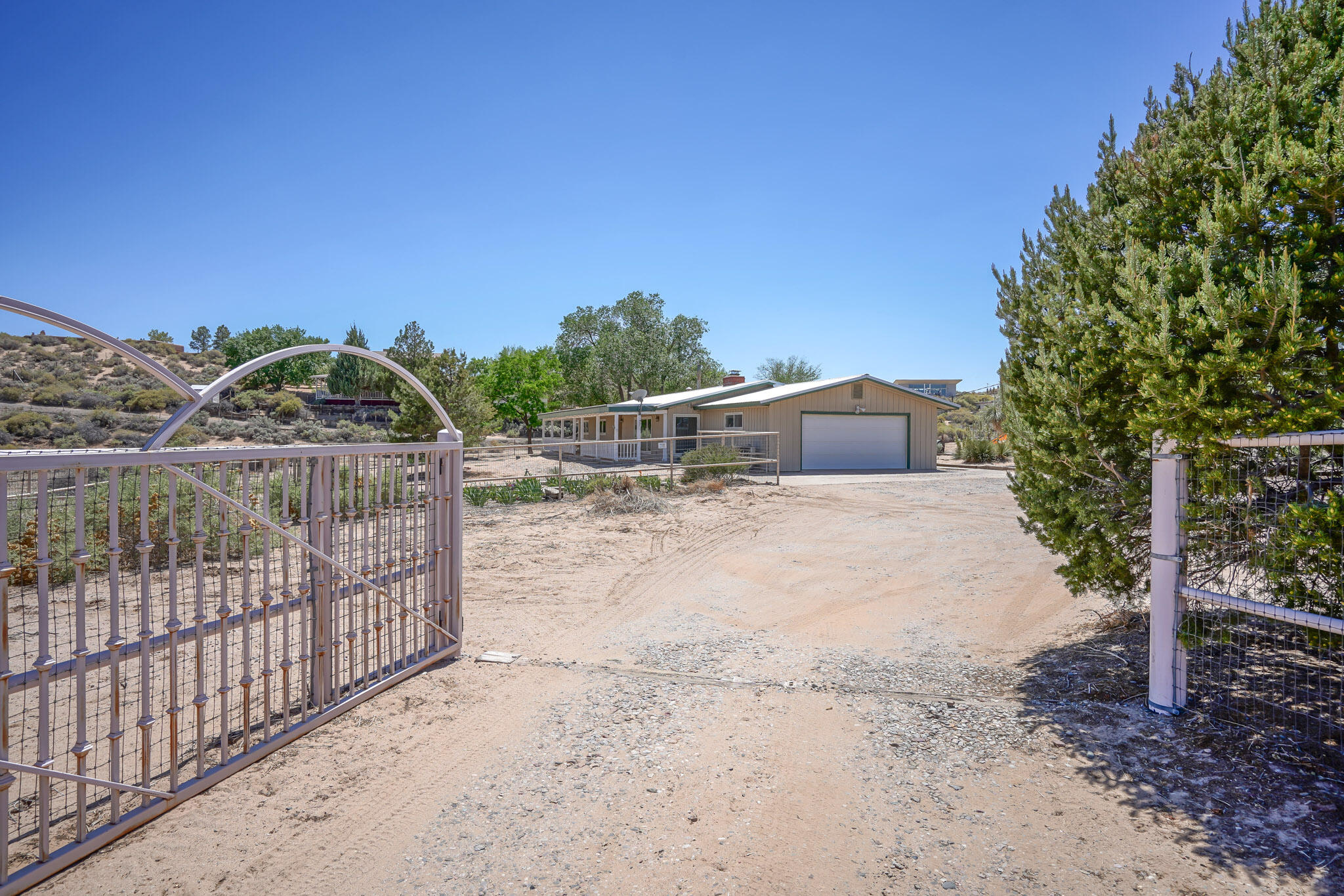 Exceptional opportunity to be a Land Baron in the safest city and horse capital of New Mexico! 3 acres of 'In-town' country in south Corrales with Sandia Mountain views, an 8 Stall Barn, Tack Room, Washing area, Hayport Barn plus separate open air stalls. Spacious level area for an outdoor arena. Site built custom  home features Andersen windows, brick wood burning fireplace in the spacious window laden gathering room, updated country kitchen, a wide front 'sitting' porch to relax upon and enjoy the views! Miles of idyllic horse trails begin at Coronado & Loma Larga just down the hill. 5 min to Cottonwood Mall; 25 min to Airport. Preference given to buyers who wish to purchase the entire 3 acres together.There is potential option of purchasing acres separately