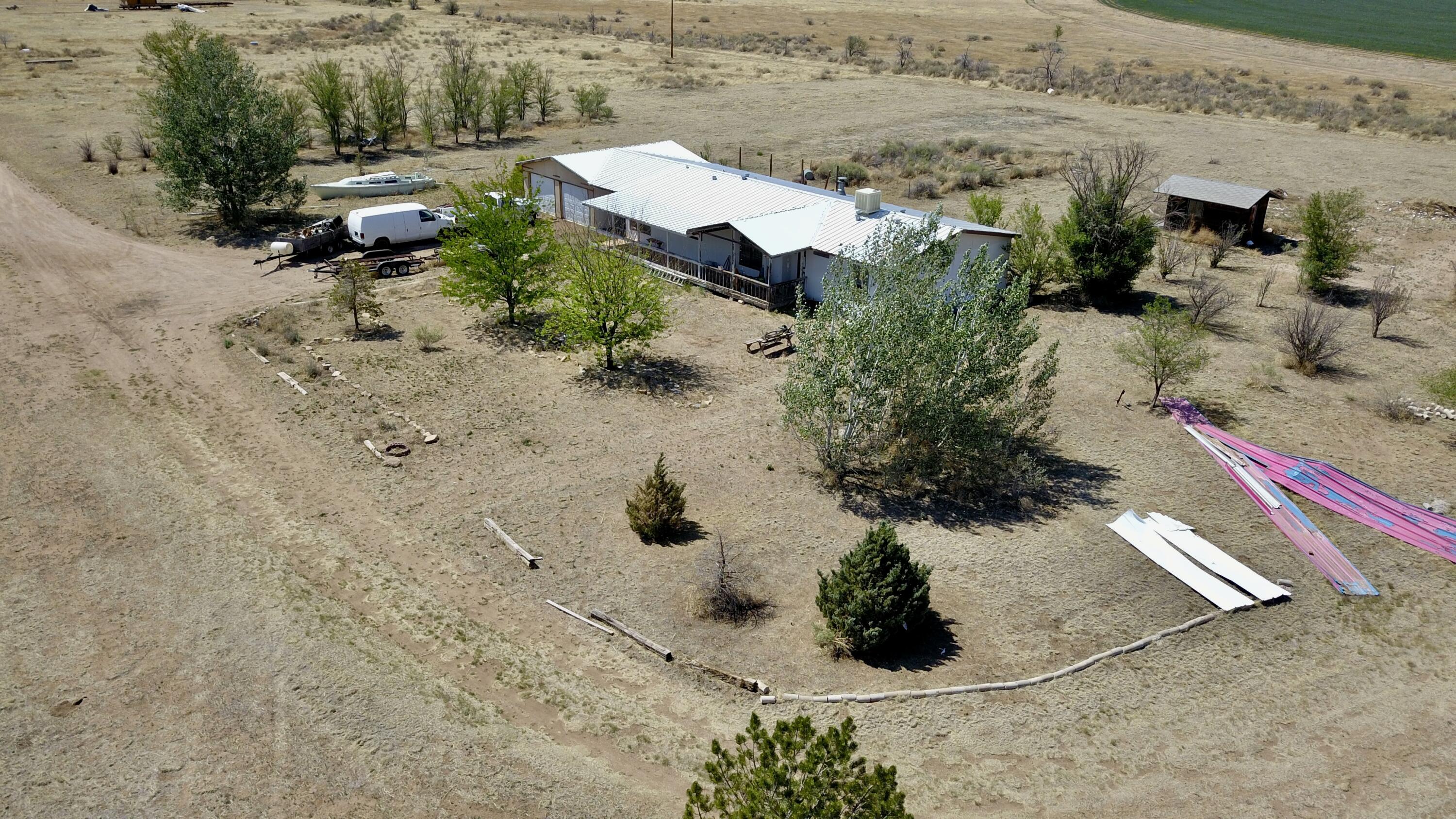 2 lots, 1 is 17.5 acres, and 1 is 2.5 acres. zoned commercial. Agricultural Preservation. Huge Metal shop (50X70) 10 foot walls and about 14 foot ceiling with electricity (includes 220) and wood burning stove. There is an irrigation well next to it (needs pump). Another 22x23 garage with 220 near that one. The house is a ground set 1995 doublewide mobile home with an attached mud room and another oversized 2 car garage. It needs some work, but definitely has potential. Flooring is already ripped out, and the laminate is there for someone to lay. needs some paint, baseboards, and some work in the master bath.  The kitchen has lots of cabinets and counter space. Walk-in pantry. Brand new well to the house.  Beautiful views with a large herd of Antelope living near by. zoned commercial,