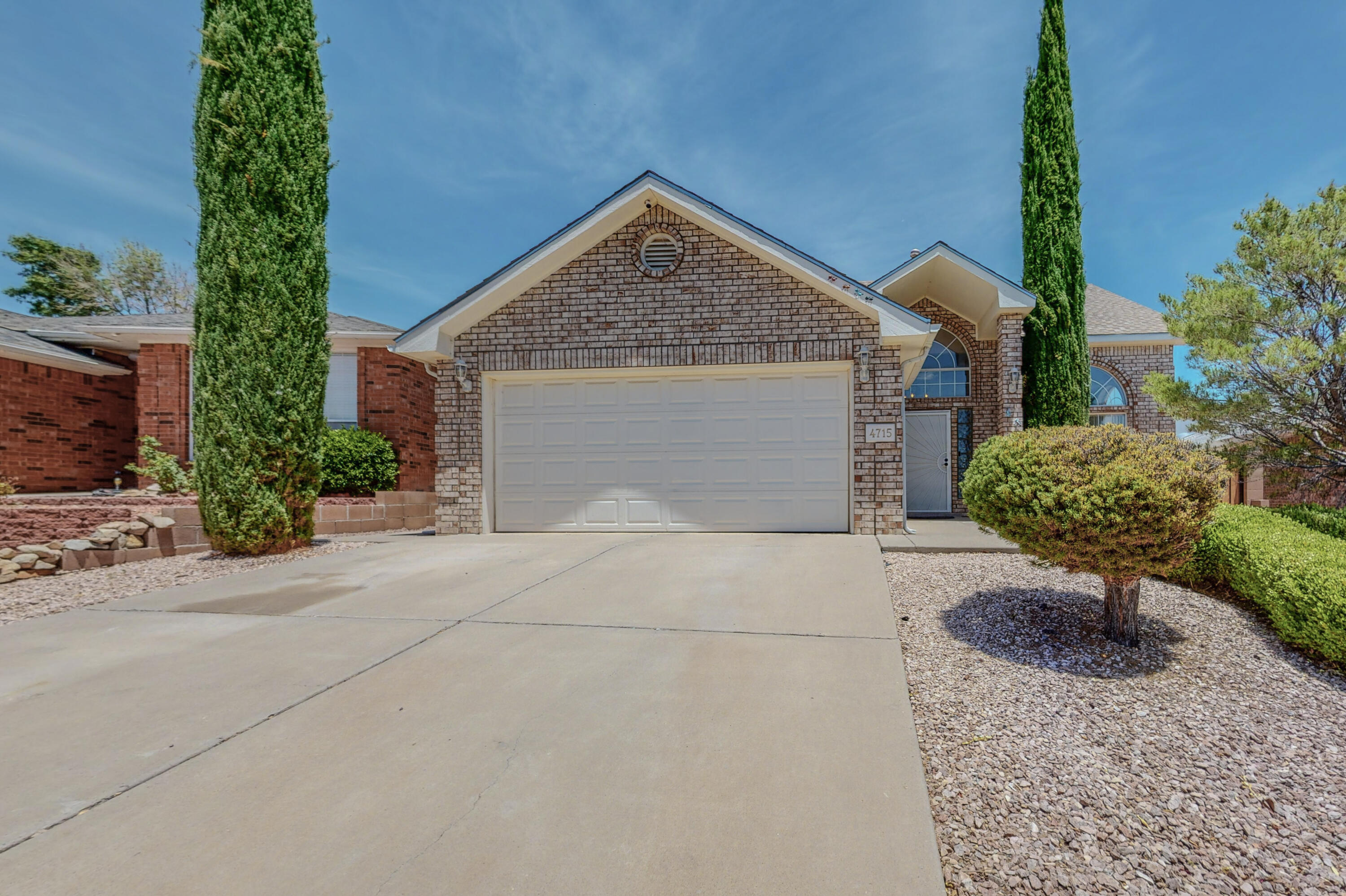 Two Story Oppel Jenkins home featuring an open, lower level living area with a fireplace, soaring ceilings, and a formal dining area. The owner's suite is on the main level with patio doors leading to the backyard and a bathroom with garden tub, separate shower and double sinks.  Spacious kitchen with an island and breakfast nook looking out to the backyard.  The upper level features a large loft with lots of natural light and windows, full bathroom, and two adjacent bedrooms.  Beautiful backyard with grass, trees, covered patio, storage shed and gazebo.  Great location near Cottonwood mall, grocery shopping, restaurants, and easy access to Paseo Del Norte.