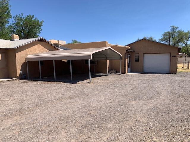This charming South Valley property is located on a fenced half acre lot with plenty of room for animals and outdoor fun. 1 car garage and a carport. Kitchen with separate dining area. Bonus room - could be a second living area or possibly a 3rd bedroom. Close to the Downtown area, UNM & KAFB. Come see it today! Property is IE (Insured Escrow: FHA insurable with up to $10,000 buyer repair escrow).