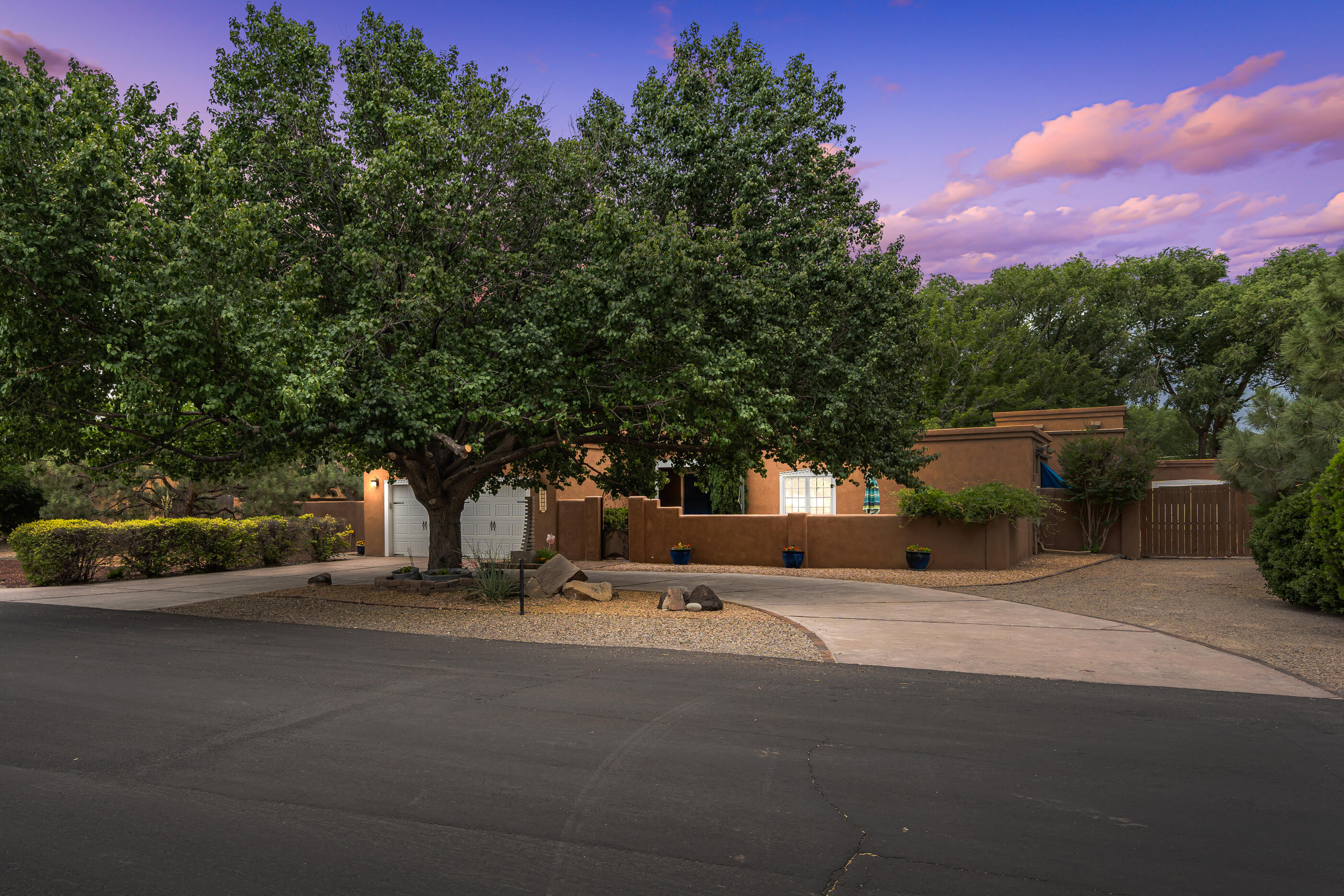 Amazing single level home on half acre in a beautiful setting in the North Valley! Endlessly appealing w/tongue-&-groove beamed Ceilings, corbels, cherry flooring & adobe accents walls. Tiled entry & water feature. Formal living room w/Fireplace. Formal dining room. Updated kitchen granite counters & breakfast nook. huge owner's suite w/adjacent study, kiva FP, walk-in closet & private spa w/jet tub & sauna. 2 add'l bedrooms, 1 add'l bath & a 2nd study/ofc. Outside: deck, salt water pool, heated gym, attachment of gym extra room/man cave/storage with running water & tasteful backyard. The roof has been replaced within the last few years to include the skylights, newer  stucco and new pool cover. come take your piece  of the north valley with this amazing home.