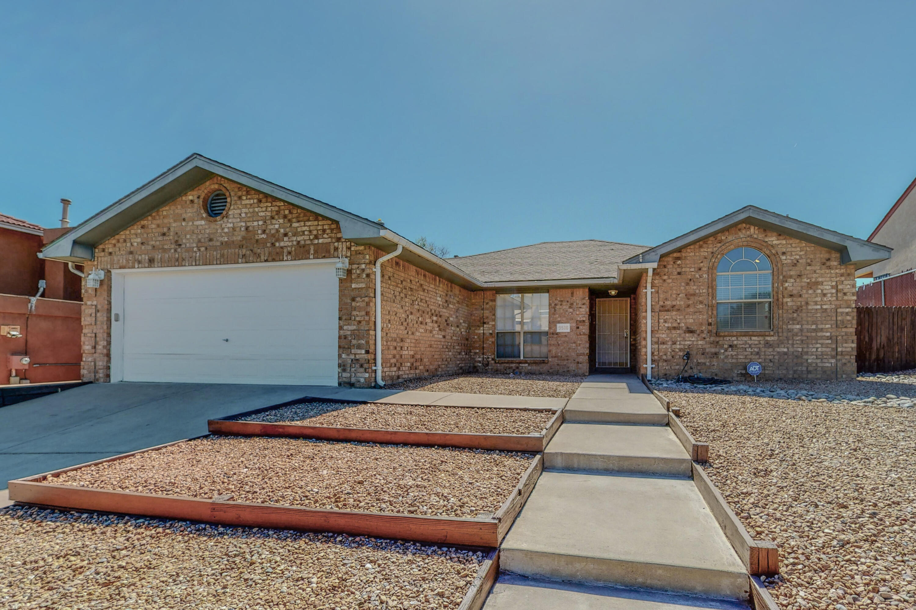 Welcome to this brick Opel Jenkins 3 bed 2 bath home! Enjoy the semi-open living, dining and kitchen floorplan with architectural details of wood trim, tray ceiling, a frame extended ceiling, unique wood trim passthroughs and through the French doors to your backyard you have an incredible view of the Sandia mountains. This home has newly painted cabinetry, newly resurfaced countertops, and updated hardware. Not to mention a fully brick exterior with a fully landscaped front and back yard with mature grass and roses. Come see this move-in-ready home!