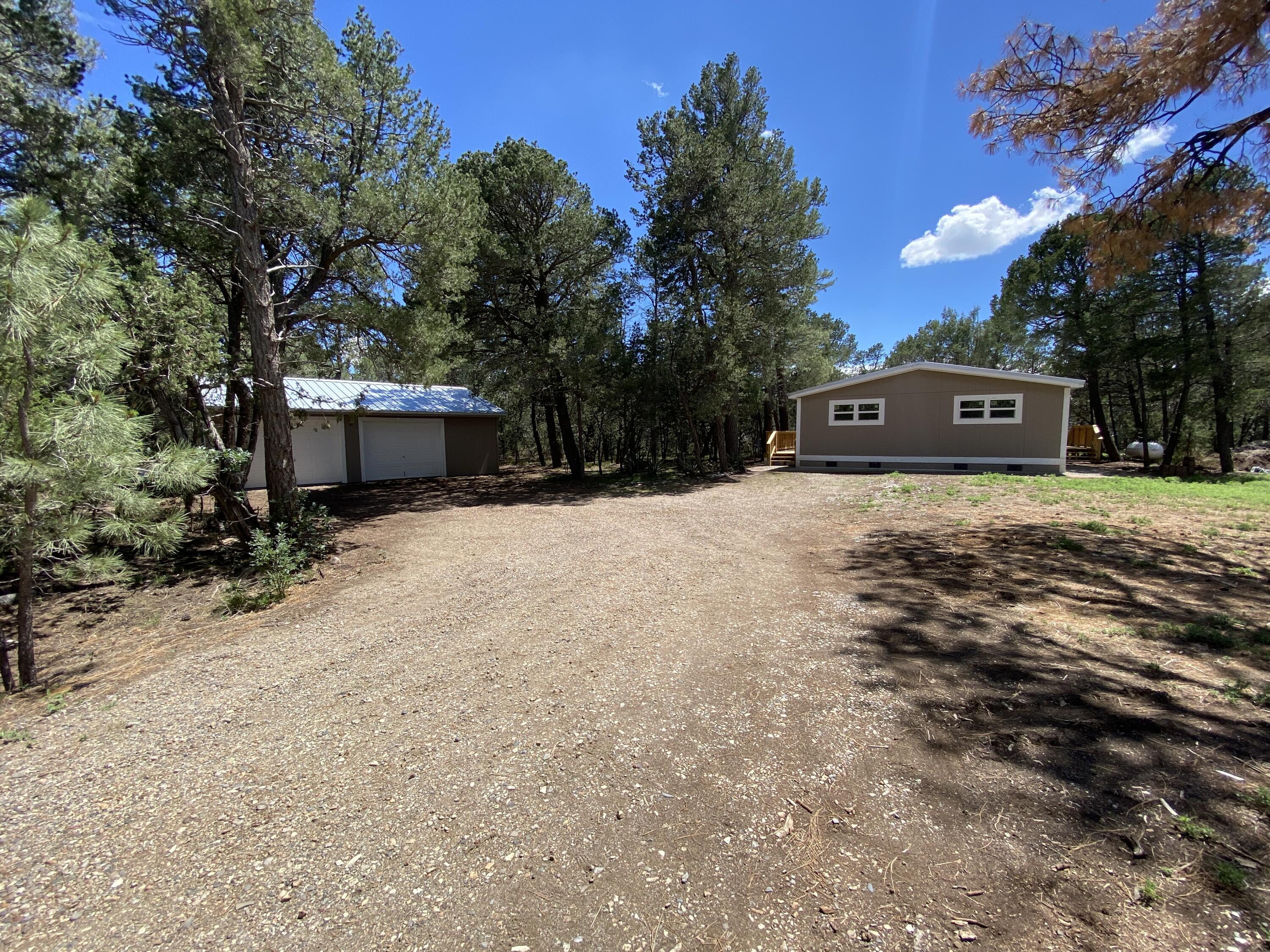 Private, beautiful 2acre lot with tall Ponderosa Pines. Totally remodeled manufactured home, 2 car detached garage, front and back decks.  Too many upgrades to list, must see.