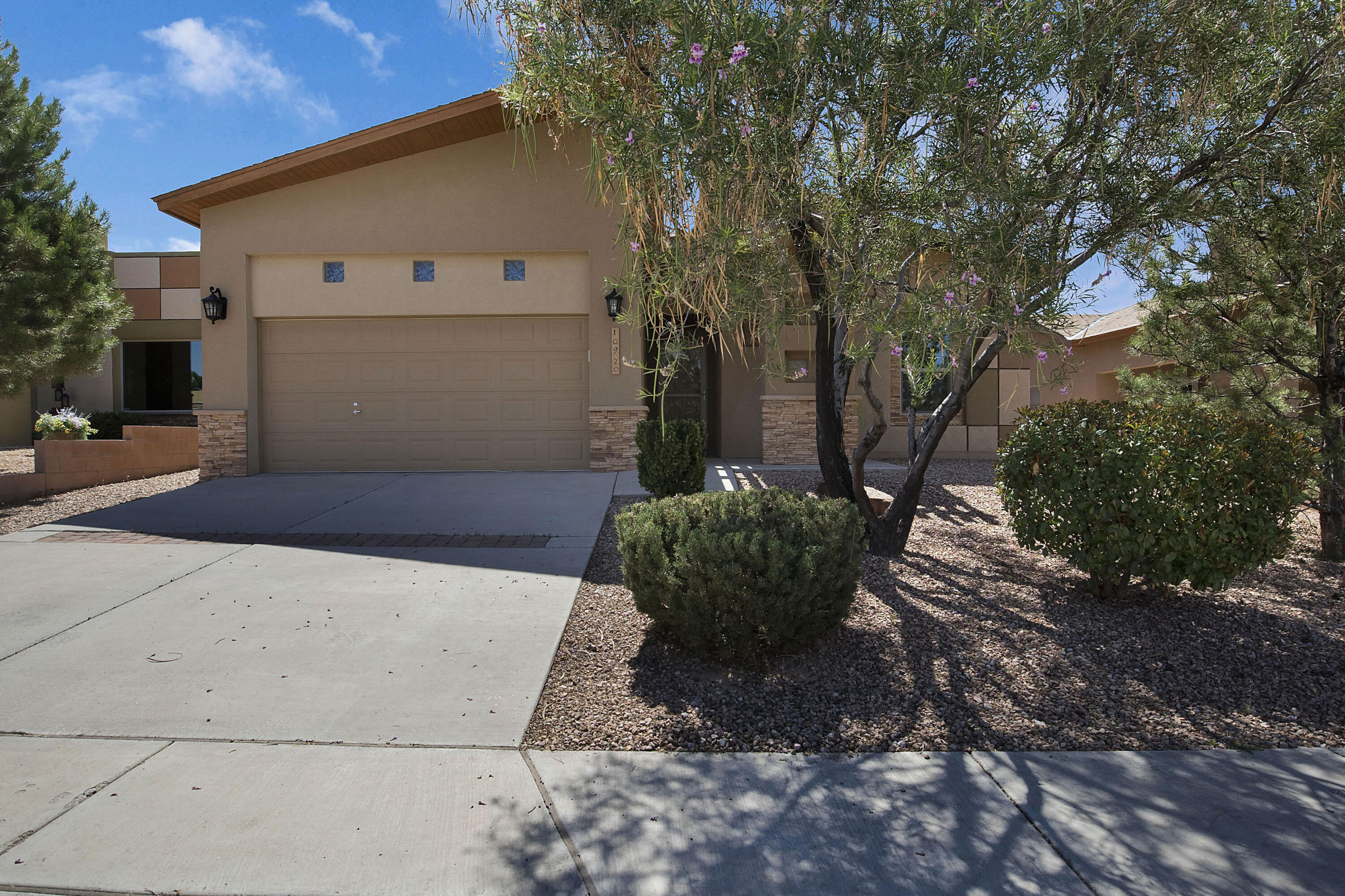 Look no further than this Build Green NM Gold-Certified Paul Allen home with owned solar panels! From the moment you arrive, you're greeted with architectural intrigue with a front wood-beam accent, pitched roofing, and a lovely foyer. Packed with energy-efficient features like R-60 insulation, a 95% efficiency rated furnace, 15 SEER refrigerated air conditioning, low-e windows, a tankless water heater, water-saving toilet flushing systems, and panasonic whisper green fans, this home is built to last. It truly looks as immaculate as it did when it was first built in 2011. THEN, you have the amazing yard with a pergola, lawn, and simple, clean landscaping around the perimeter. Imagine leaving the lights on, air blasting, and having no or low electric bills!