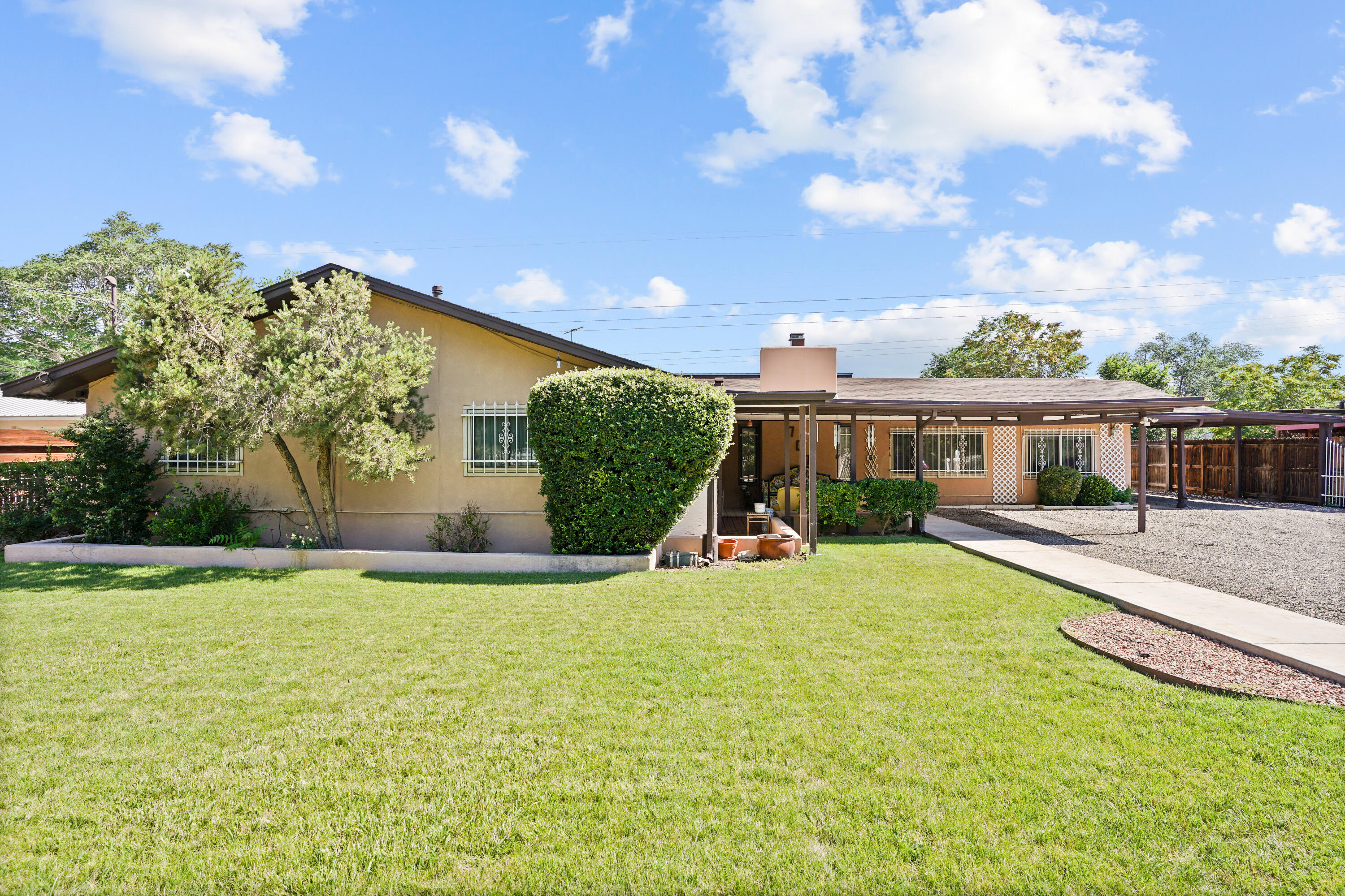 Well Maintained home in the heart of Los Ranchos!  This single story sprawl features an updated roof, manicured landscaping, updated windows, backyard access, and a fully fenced .5 acre of land.  Main home includes 3 bedrooms, 2 baths, and a large 2nd living area.  Attached in-law quarters features a one bedroom, and full kitchen.  The casita in the back is a studio with a private kitchen, bath, and access to laundry.