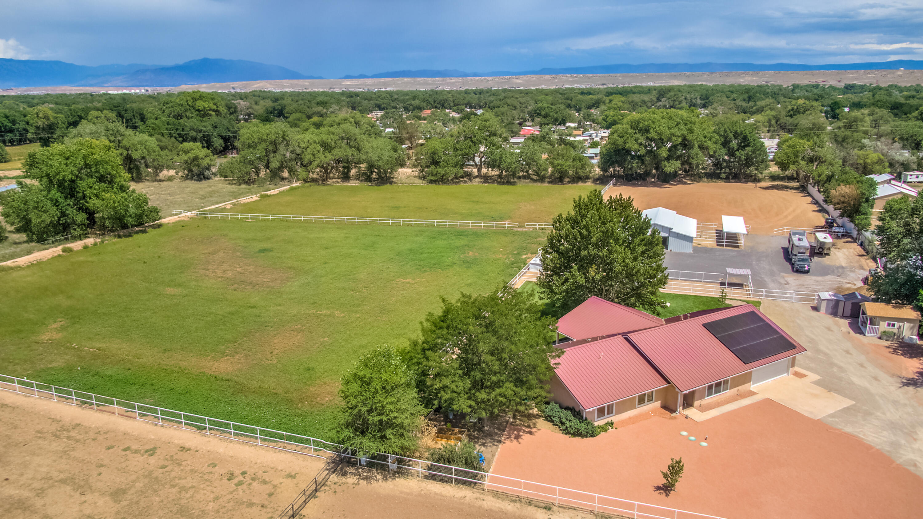 Bring the horses!  This fabulous farm is ''turn key'' for the equestrian.  Situated on 4.85 acres,  irrigated pastures, large arena, 5 stall barn, tack w/laundry, wash area, hay storage, turn outs, pipe fencing and privacy!   Ranch style 3BR home w/2 living areas, 2BA, mud room, heated/cooled 2 CGar, sauna, solar panels owned & generator system. Separate office. Beautifully designed home offers an open floor plan which makes this a great house for living & entertainment.  The kitchen features a large island, gas stove, oak cabinets and granite countertops w access to the large back patio, plus view of the horses.  This  well-maintained property is  completely fenced with a gated entry.  Great location  within minutes to I-25 off Isleta.  Access to trails for riding, biking, or walking.