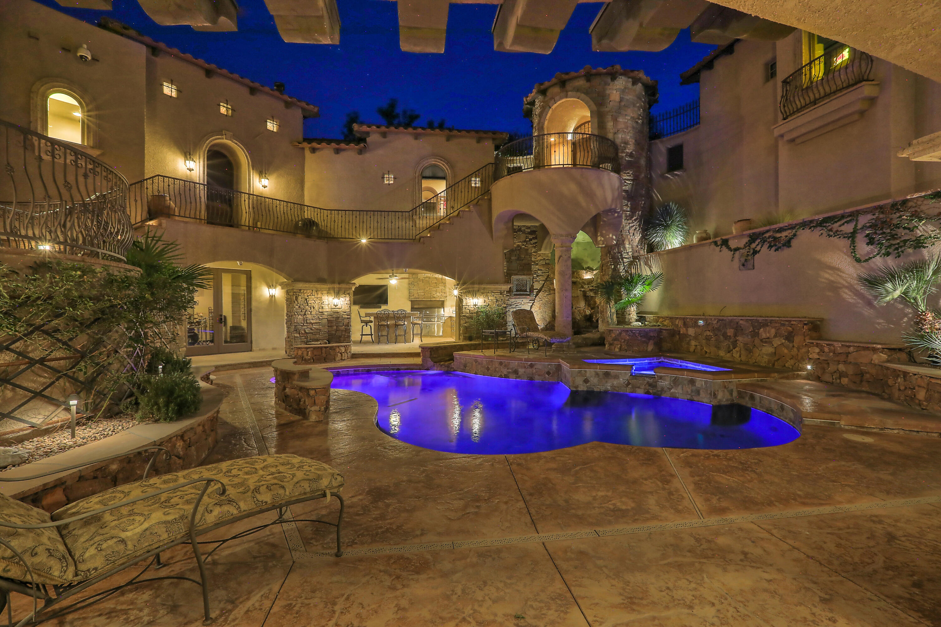 Stunning Tuscan villa a stone's throw from the Rio Grande, fine dining & recreation. Over 7,000 square feet of luxury w/every amenity & convenience included. From the marble floors to the mosaic tiled & wood beam ceiling, this home is your retreat. The gourmet chef's kitchen boasts top-of-the-line appliances, pot filler, custom tile, dual sinks, breakfast nook w/a breathtaking view, & enough space to entertain the whole neighborhood. Pool features stone waterfall, custom lighting for night swims & a wraparound balcony & terrace to enjoy every vista. Multiple covered lounge & dining spaces, hobbyist's dream garage, workout room, media & game room & spa bathrooms. Too many one-of-a-kind luxuries to list. If a private resort is what you're after, you can't miss this beautiful palazzo!