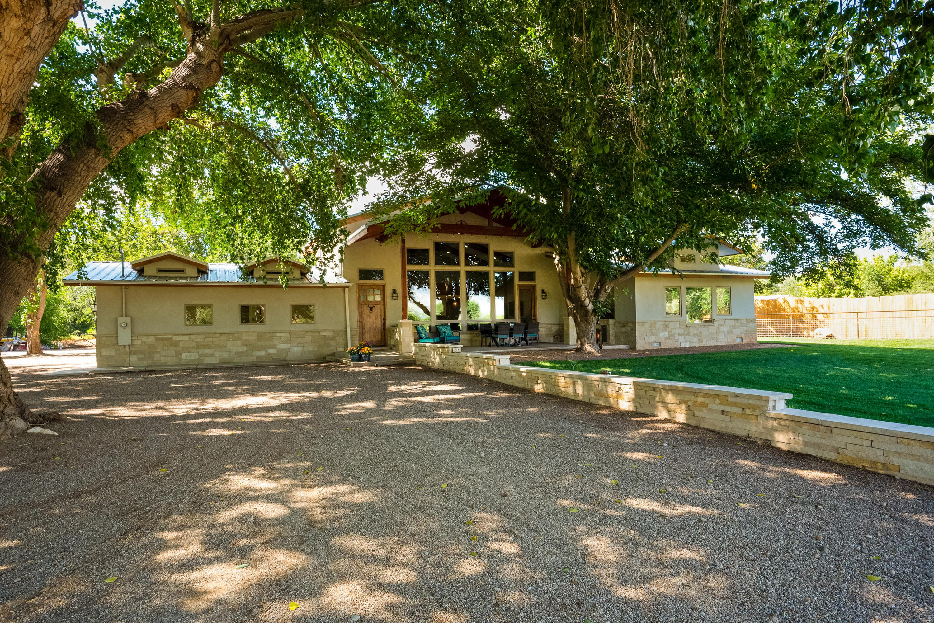 Completely renovated in 2019, this 3 acre premier Corrales greenbelt  property surrounded by Cottonwoods is special! Walk or ride directly onto ditch path. A stunning new home with a versatile floorplan offers 4 bedrooms, a playroom, office, laundry & mud room. The greatroom/kitchen has panoramic views of the Sandias, Jenn-aire stainless appliances, a barn door pantry, custom cabinetry with granite tops. The Owners Quarters has a breathtaking view of the Sandias and spa like bathroom with marble tops and Travertine floors. An outdoor kitchen graces the front portal while an 1130 s.f. shop with 8' doors and 220 Volt enhances the back. A pipe fence with 6 gage wire and electric gate surrounds the property. There's a complete RV hook up and 3 horse stalls with an alley. Read Special Features!